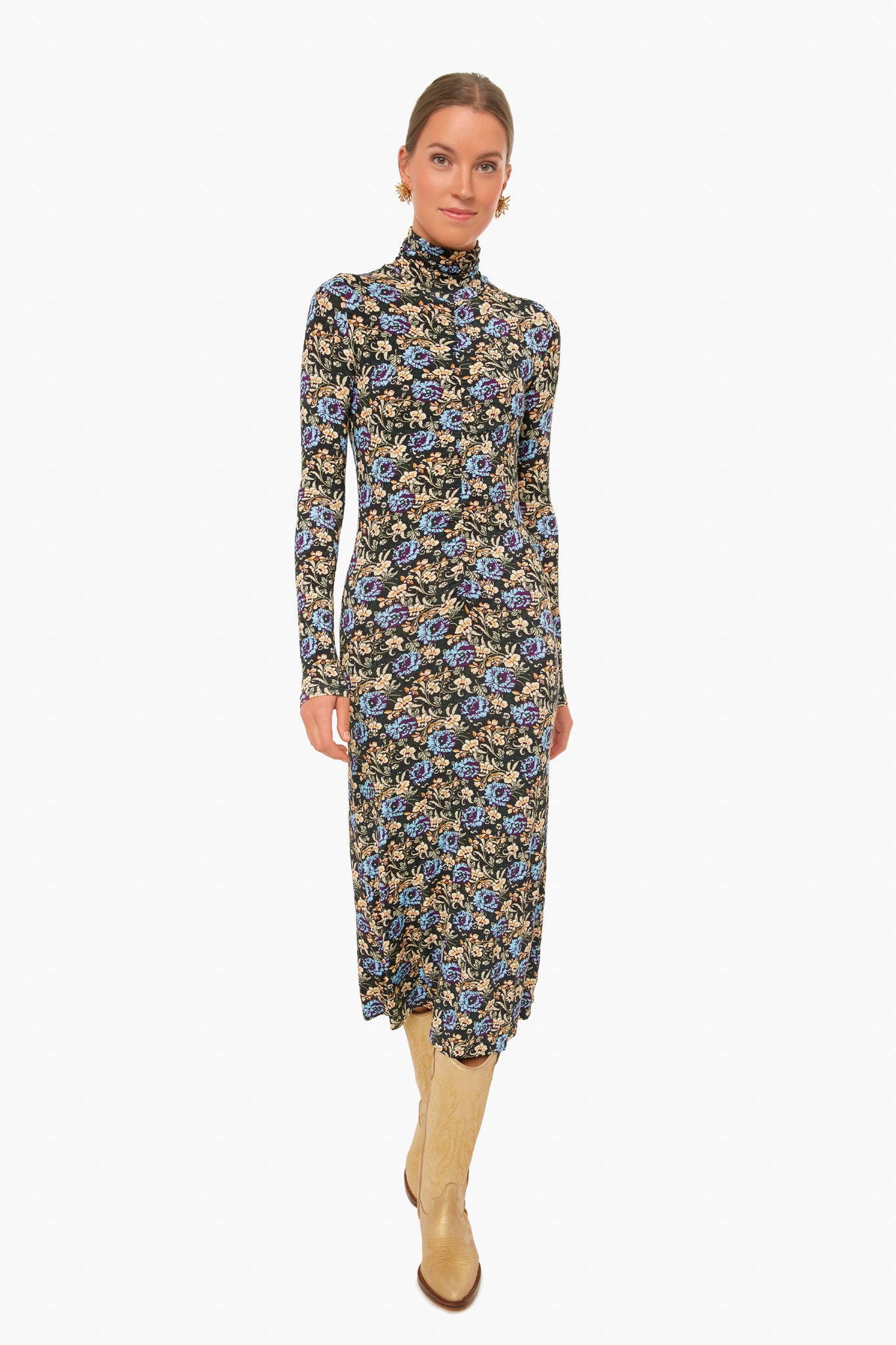 A woman wearing a RHODE floral midi dress with long sleeves and a high neck, paired with light-colored knee-high boots.