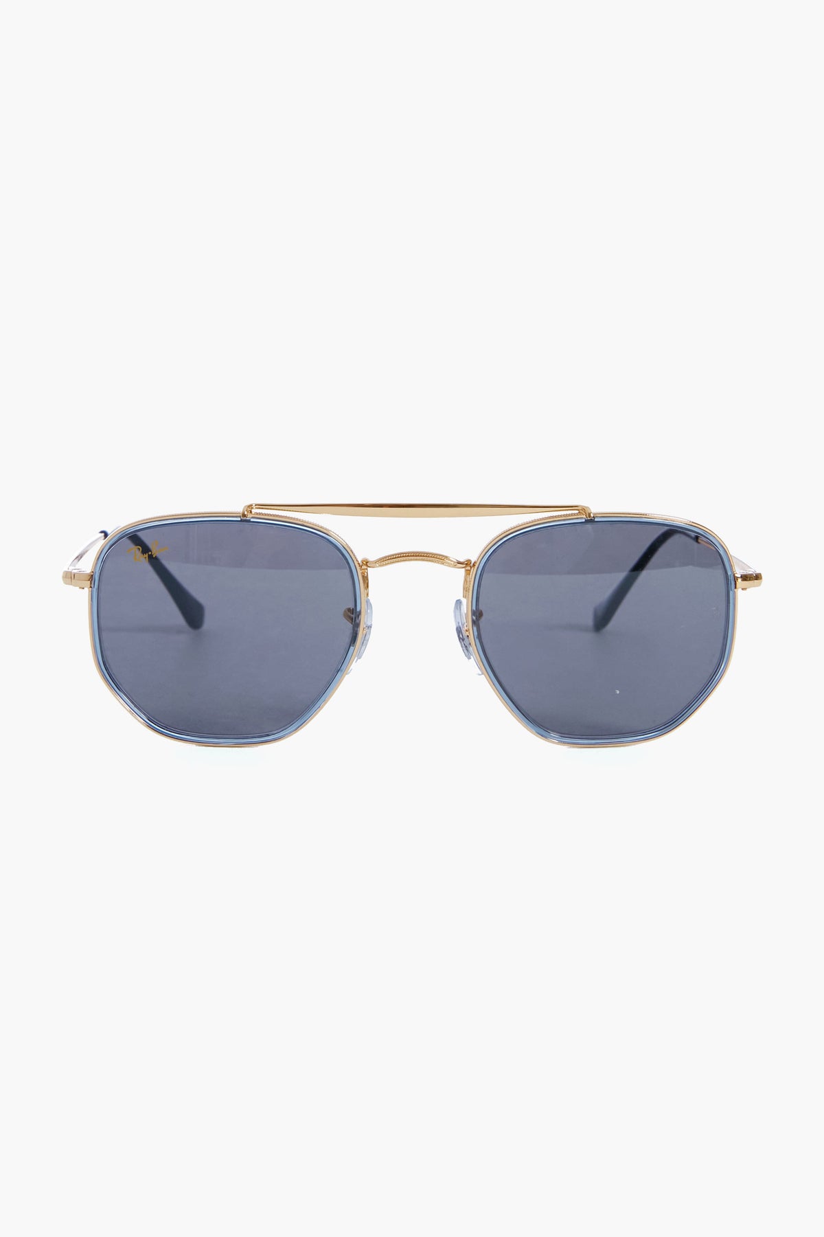 Ray-Ban gold-framed aviator sunglasses feature gradient blue-tinted lenses and hexagonal metallic frames.