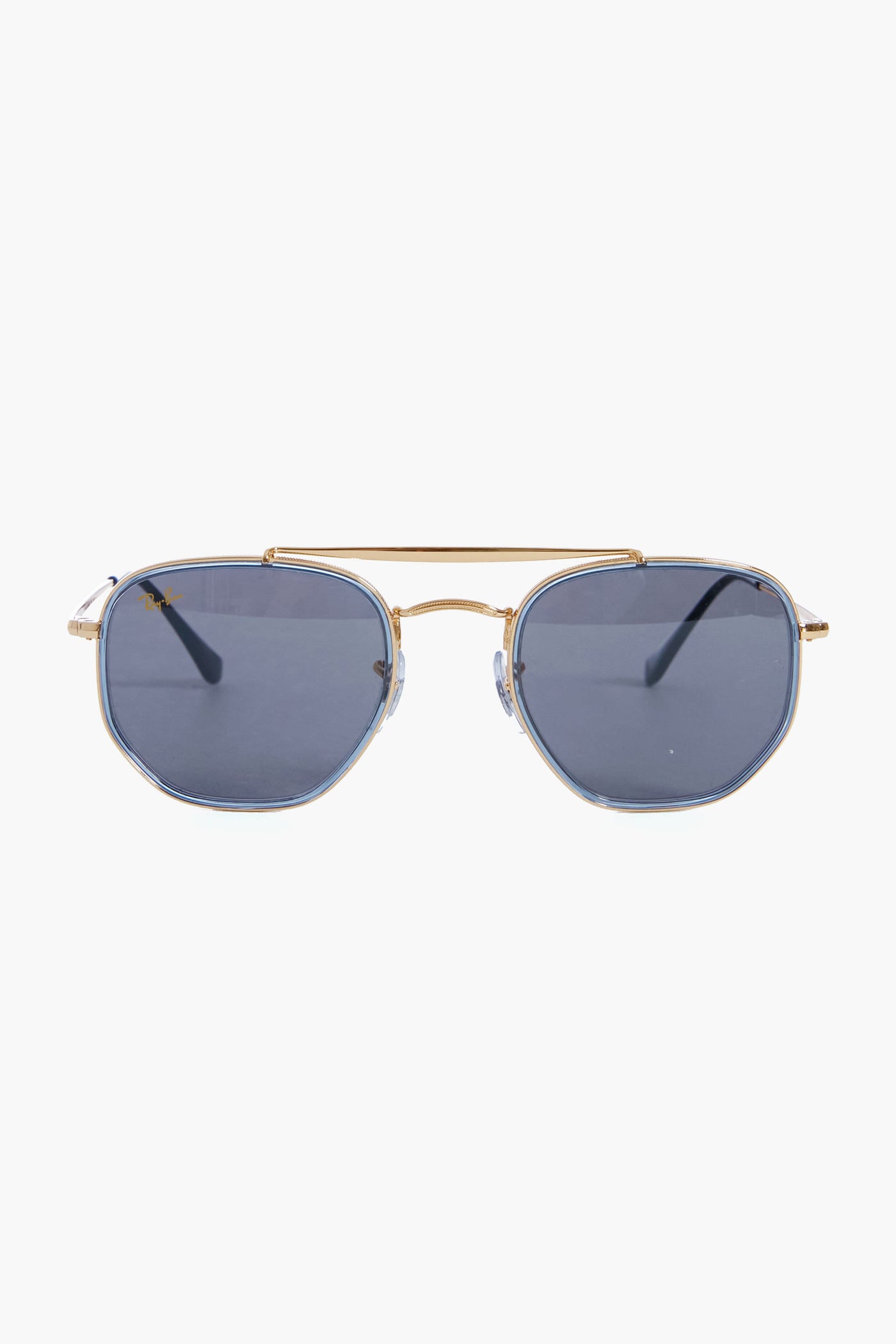Ray-Ban gold-framed aviator sunglasses feature gradient blue-tinted lenses and hexagonal metallic frames.