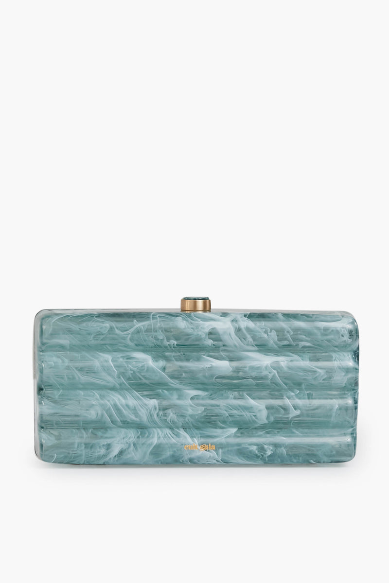 The Cult Gaia Seaspray Enid Clutch is a rectangular, blue-green marble-patterned accessory with a gold clasp and small gold logo—a unique statement piece.