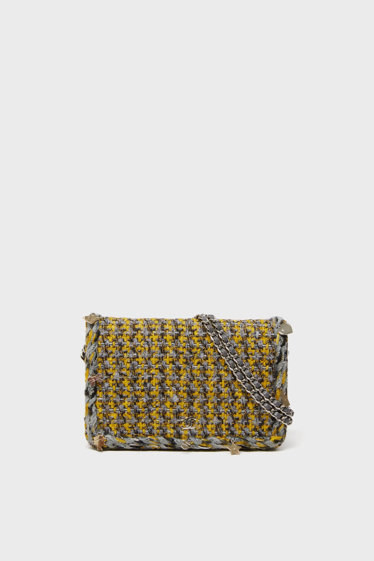 A rectangular shoulder bag from the Tuckernuck Archive Collection, with a yellow and gray tweed pattern and silver chain strap, inspired by the Classic Flap Bag design.
