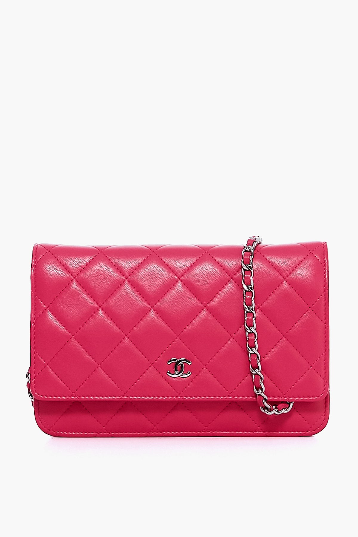 A Tuckernuck Archive Collection Wallet on Chain, featuring quilted pink leather, a silver chain strap, and a metal logo emblem on the front flap.