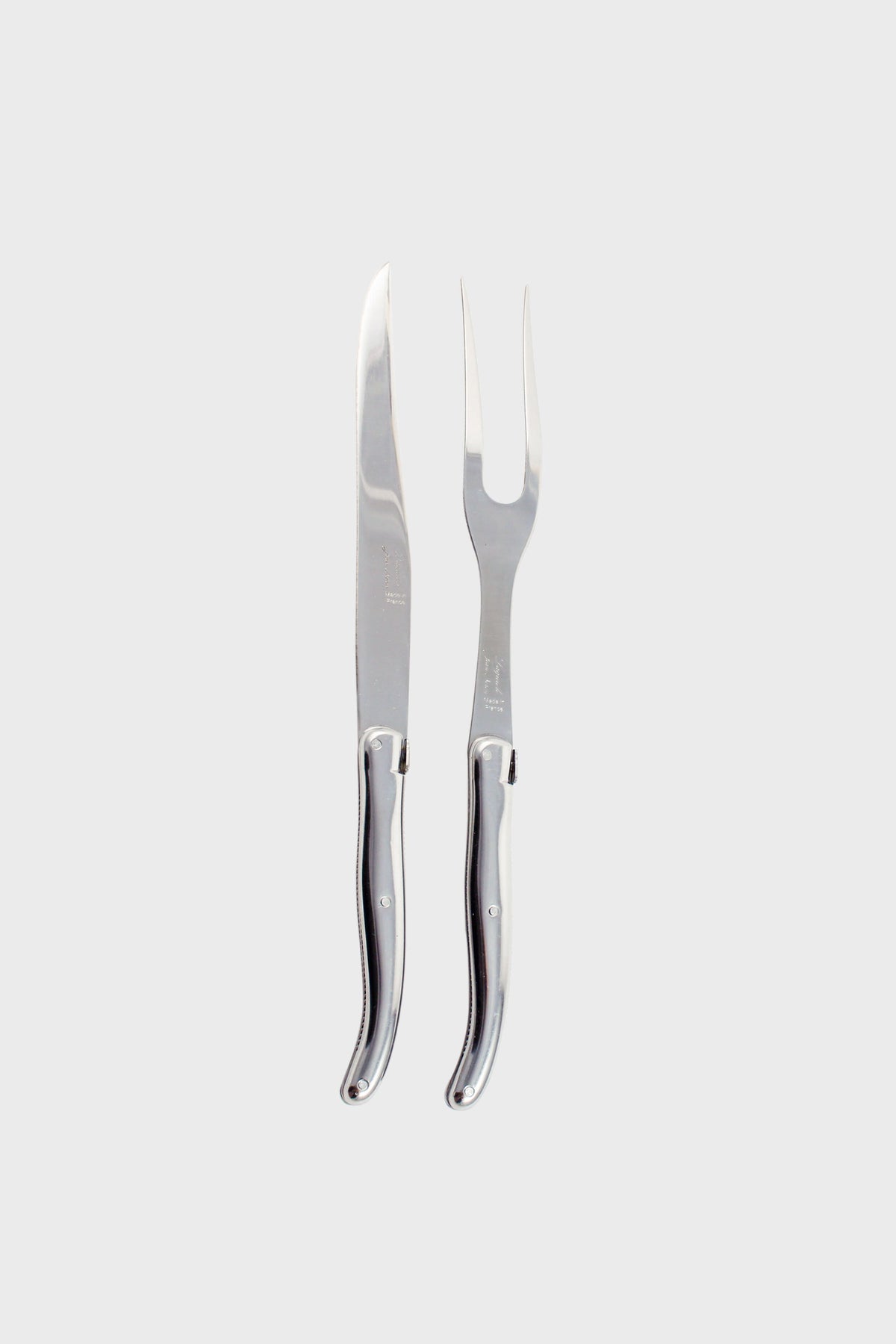 The Laguiole carving set includes a stainless steel carving knife and a matching two-pronged fork, both with coordinated handles, arranged side by side.