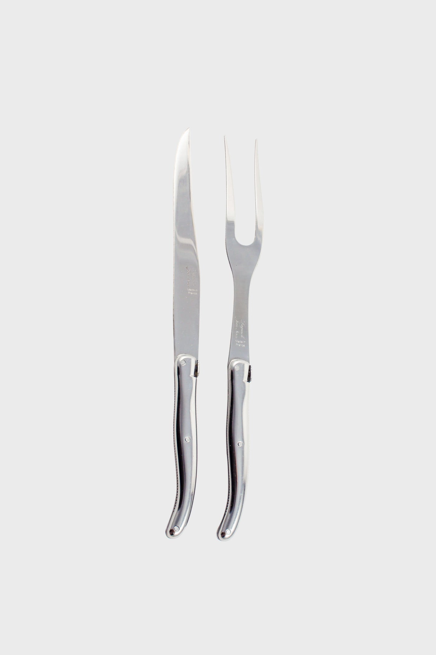 The Laguiole carving set includes a stainless steel carving knife and a matching two-pronged fork, both with coordinated handles, arranged side by side.