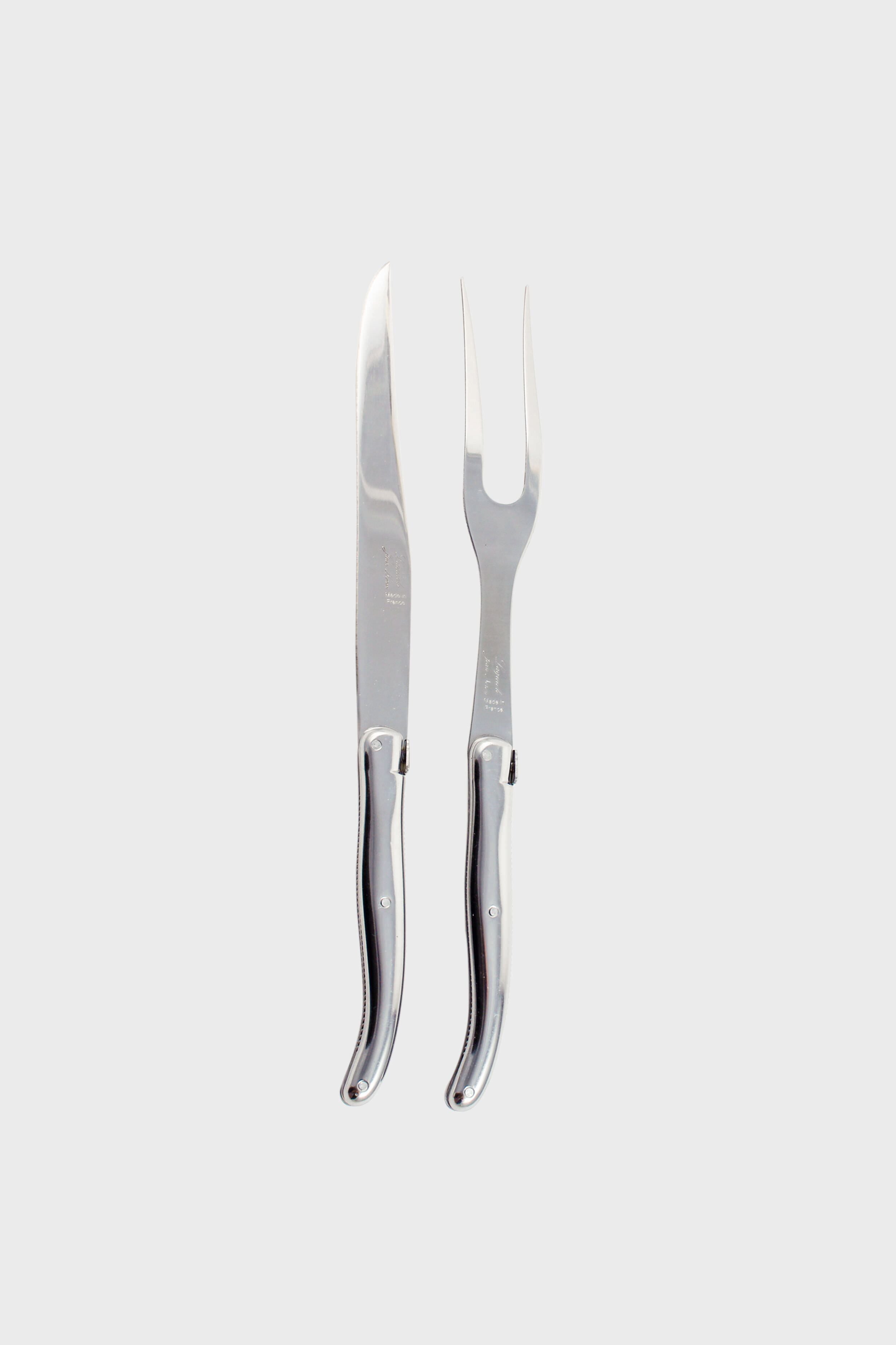 The Laguiole carving set includes a stainless steel carving knife and a matching two-pronged fork, both with coordinated handles, arranged side by side.