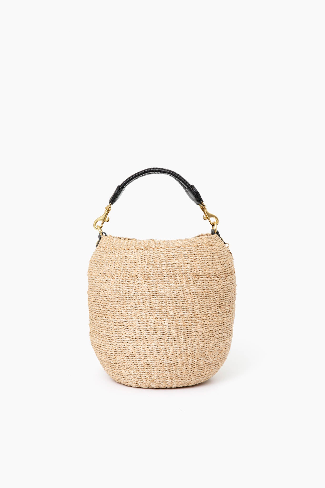 Clare V's round woven straw bag features a short black top handle and gold hardware, offering a stylish, modern look.