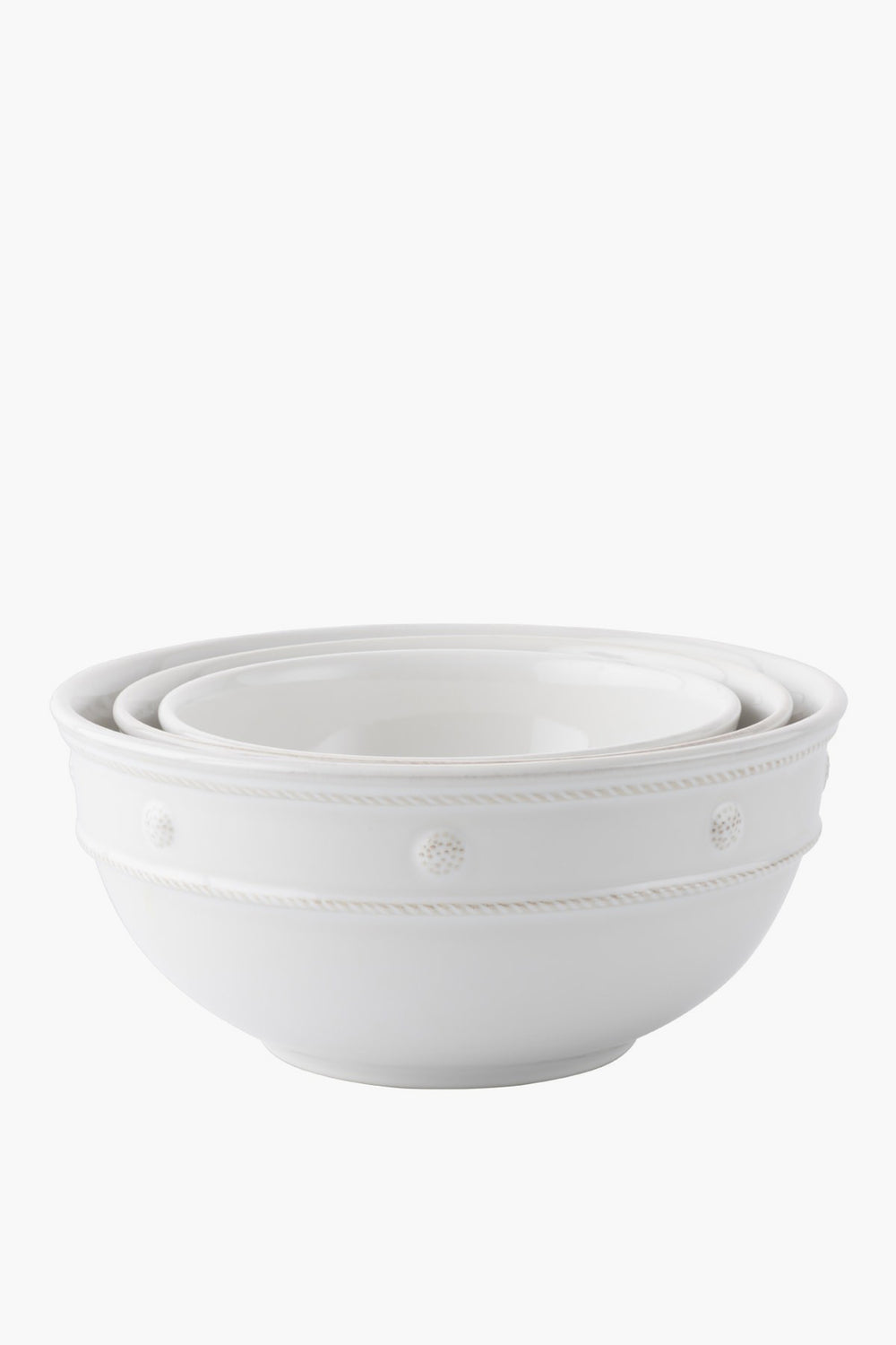 Three white ceramic stoneware mixing bowls by Juliska nest inside each other and feature a simple embossed dot and rope design along the rim—ideal for serving.