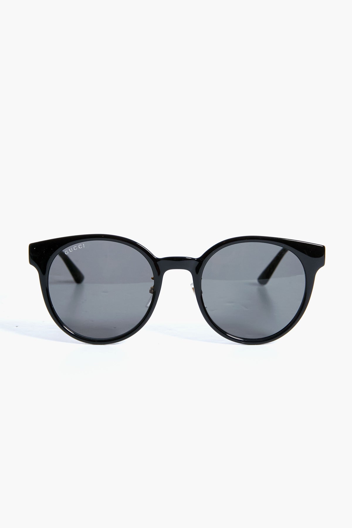Gucci black round sunglasses with dark lenses and straight arms, featuring a stylish round frame and luxury fashion appeal.