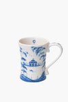 Juliska white ceramic stoneware mug features a blue pastoral scene with trees, building, balloon, birds, and boat. Curved handle. Dishwasher safe. Made in Portugal.