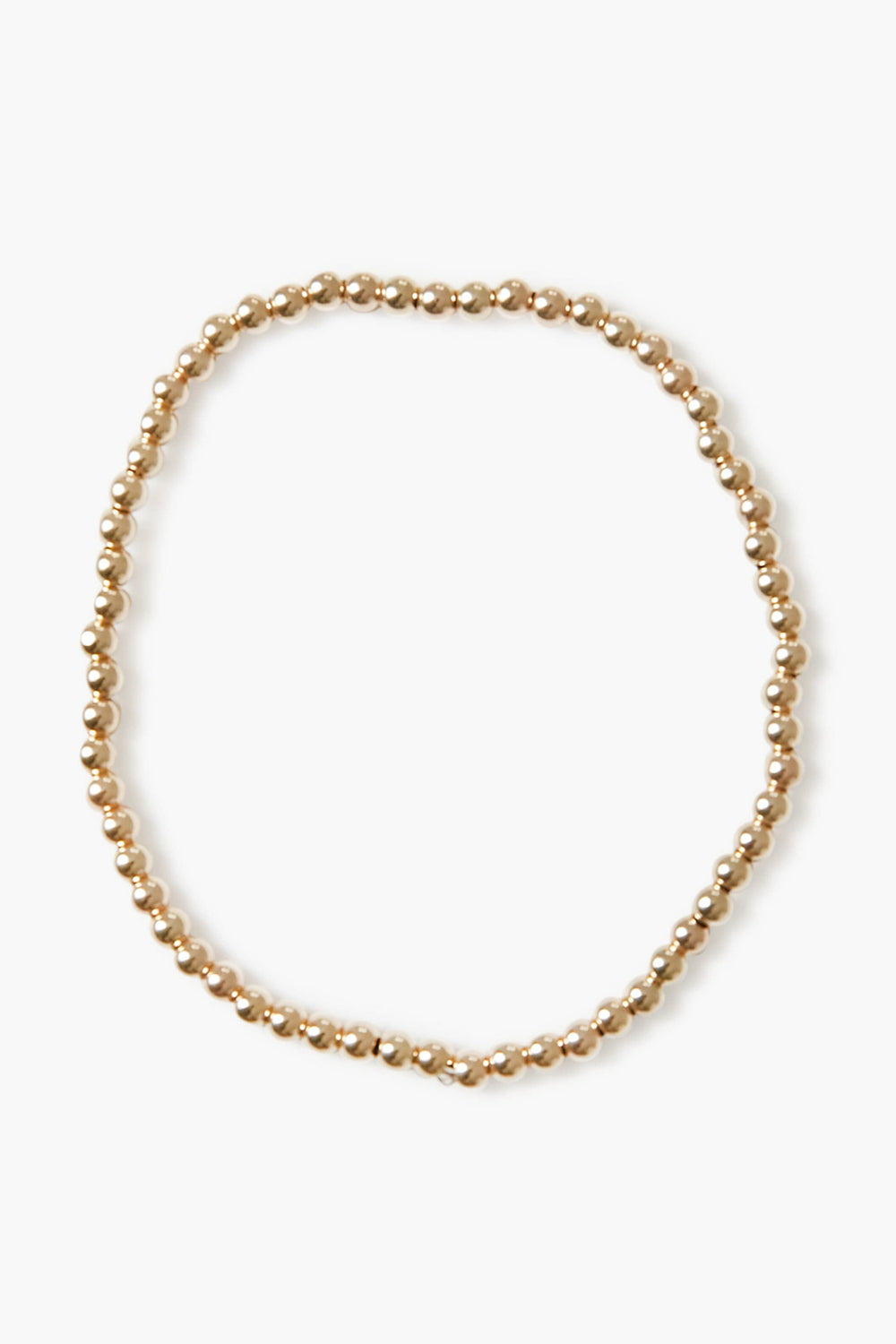 Alexa Leigh gold beaded necklace arranged in a loose circle, echoing the look of a stacking or gold ball bracelet, crafted with 14k gold plated elegance.