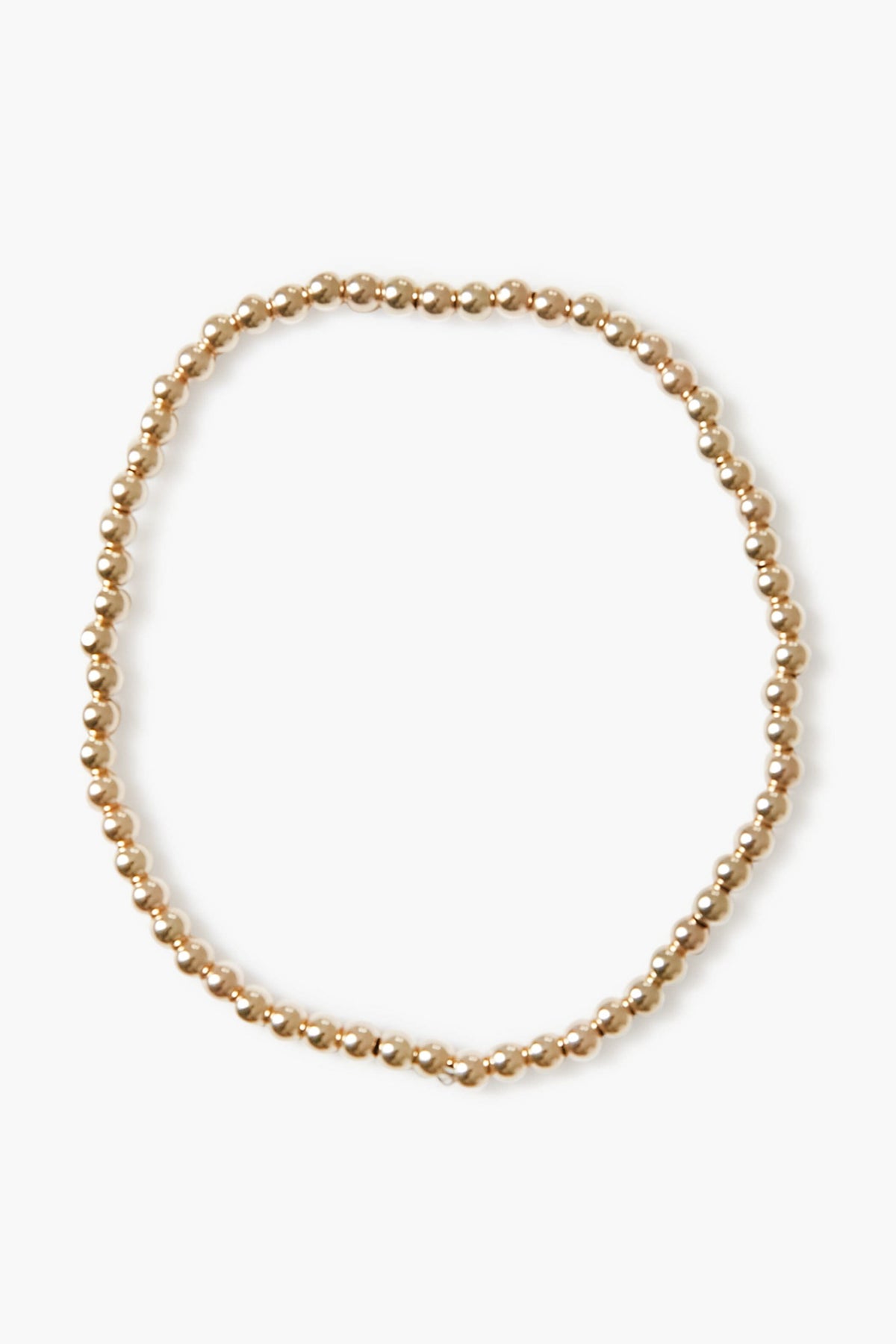 Alexa Leigh gold beaded necklace arranged in a loose circle, echoing the look of a stacking or gold ball bracelet, crafted with 14k gold plated elegance.