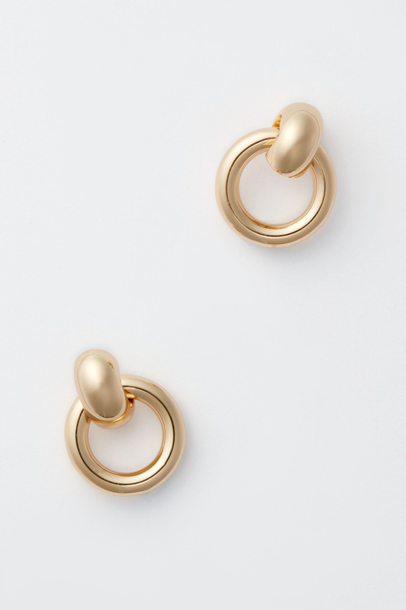Minimalist gold hoop earrings by Jenny Bird featuring a rounded, smooth design—an ideal addition to any minimalist earring collection.