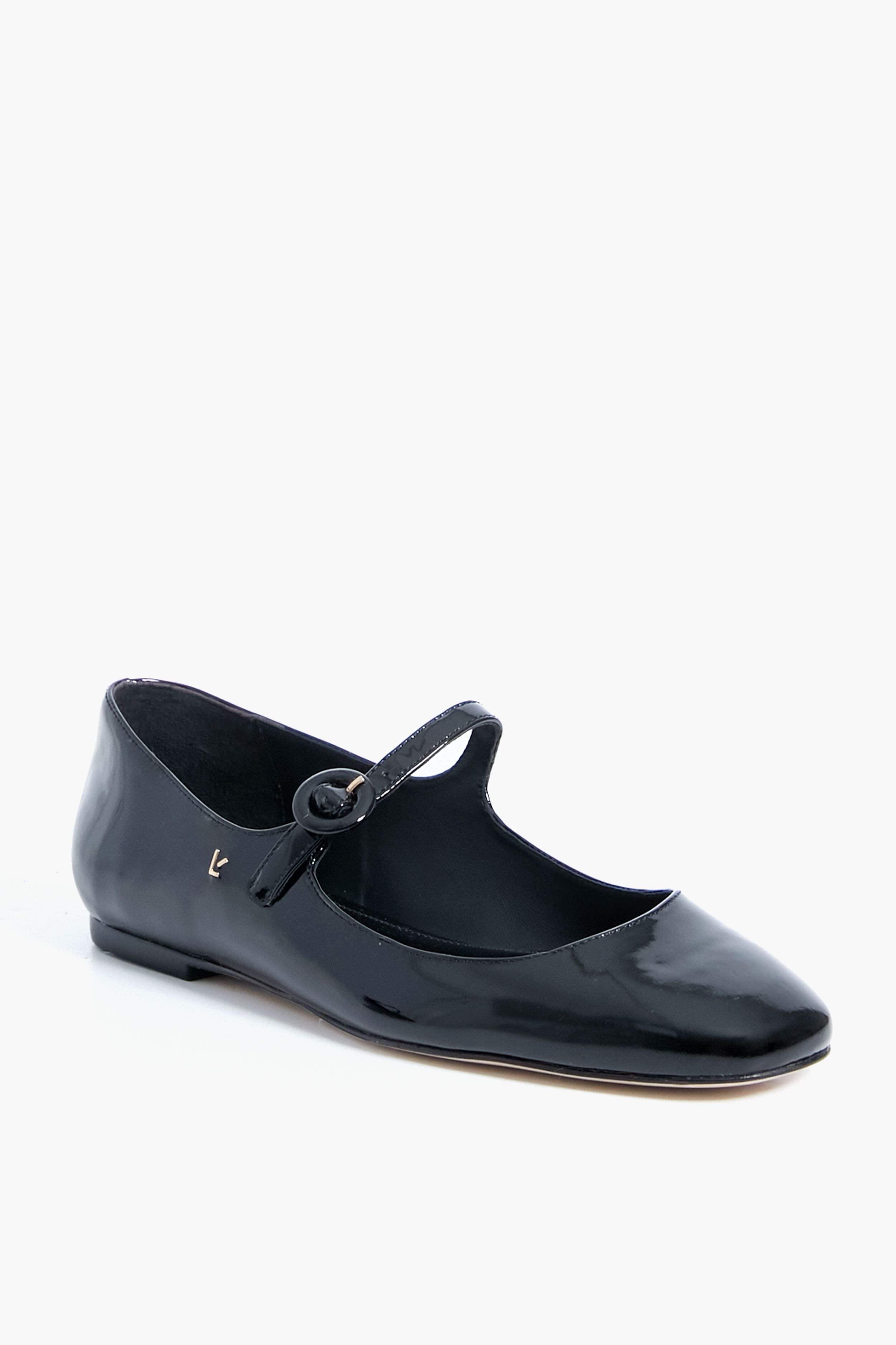 The Larroude Black Blair Ballet Flat features black patent leather, a single strap, round toe, and a memory foam cushioned insole for all-day comfort.