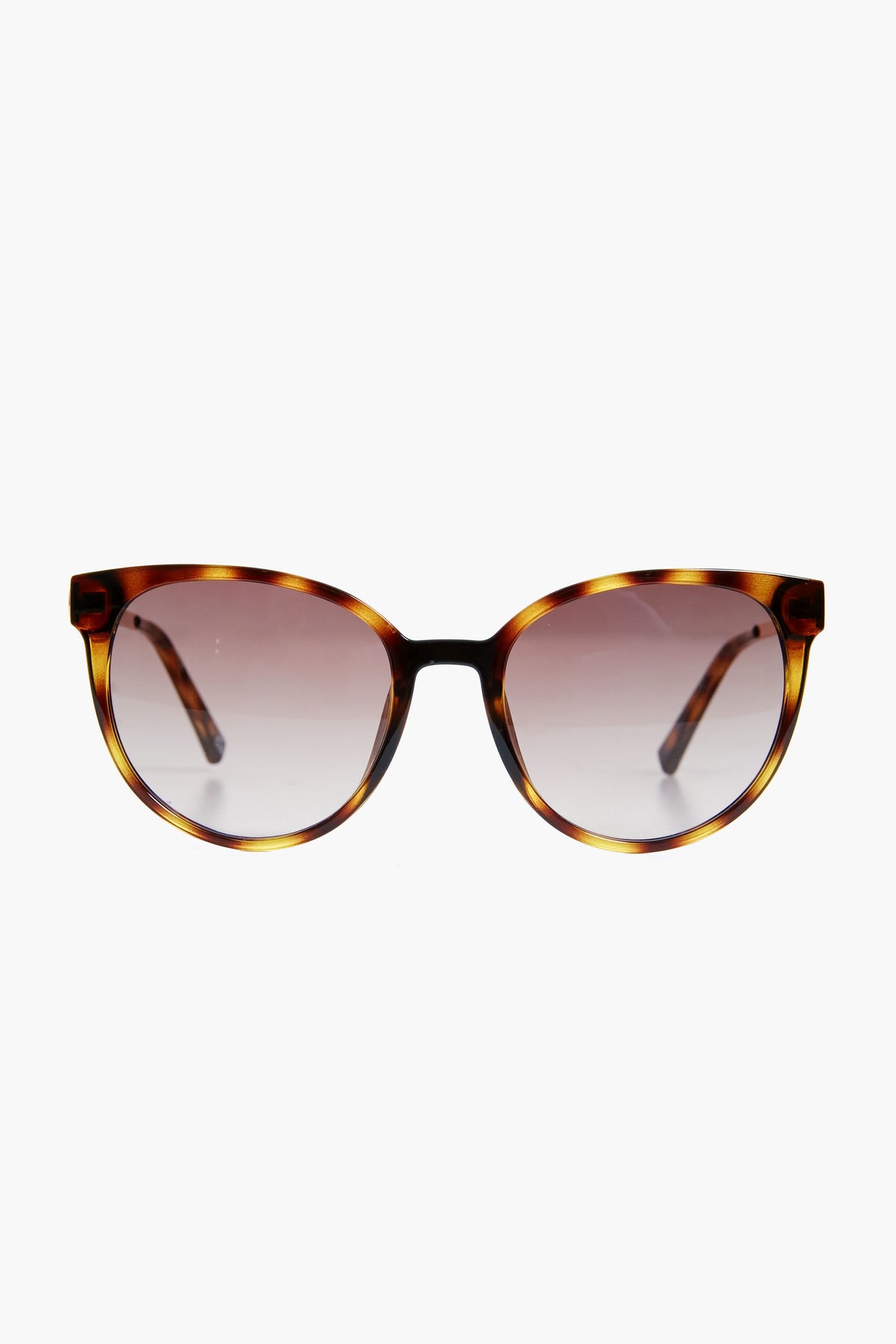 Le Specs cat-eye sunglasses in a vintage round style, featuring tortoiseshell frames and gradient lenses.