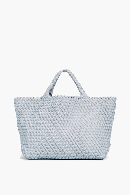 Light blue woven neoprene tote bag by Naghedi, featuring two short handles and the brand's signature style.