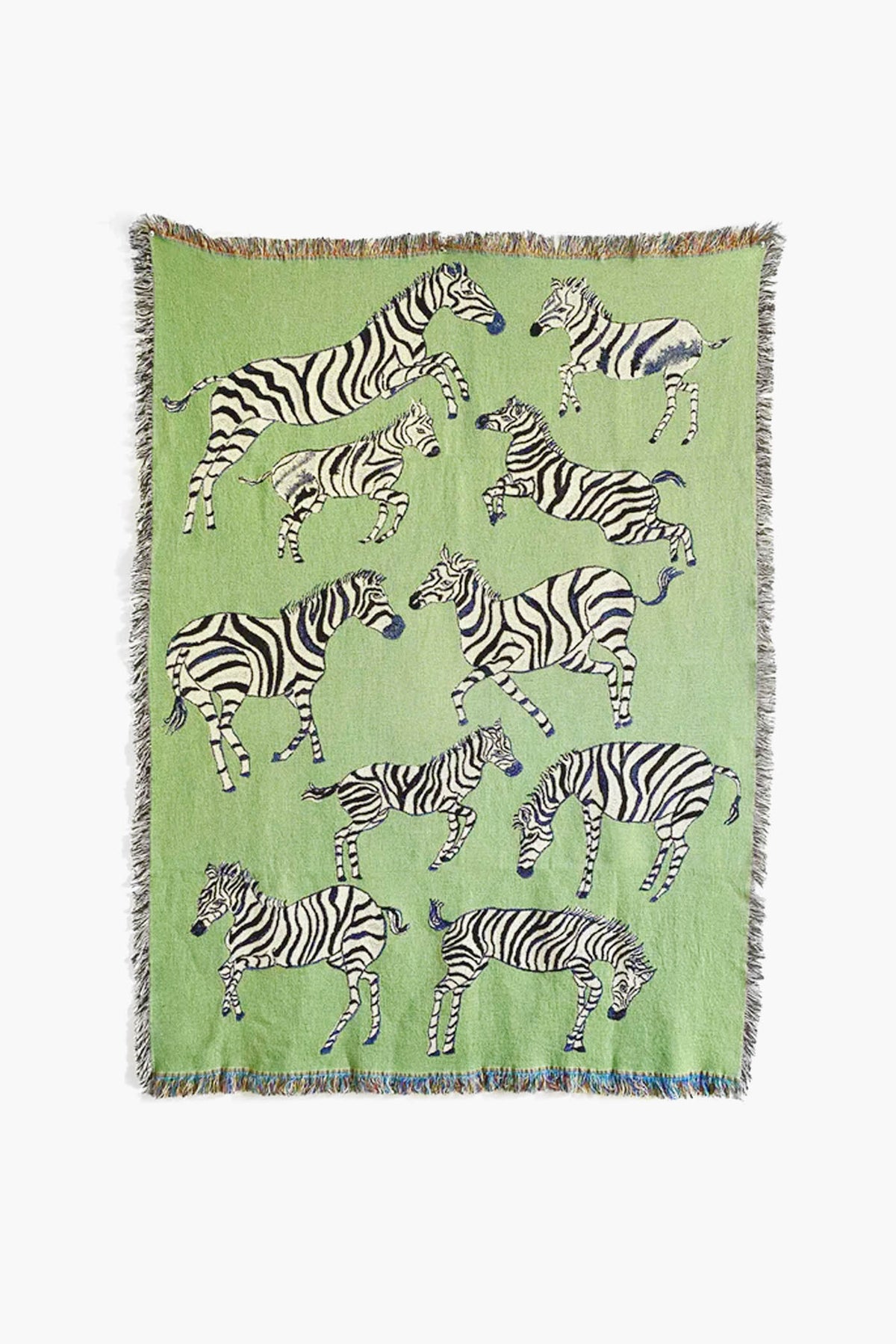 The Olivia Wendel Green Zebras Blanket is a lightweight throw made from 100% US-grown cotton, featuring playful black and white zebras in various poses on a green background.