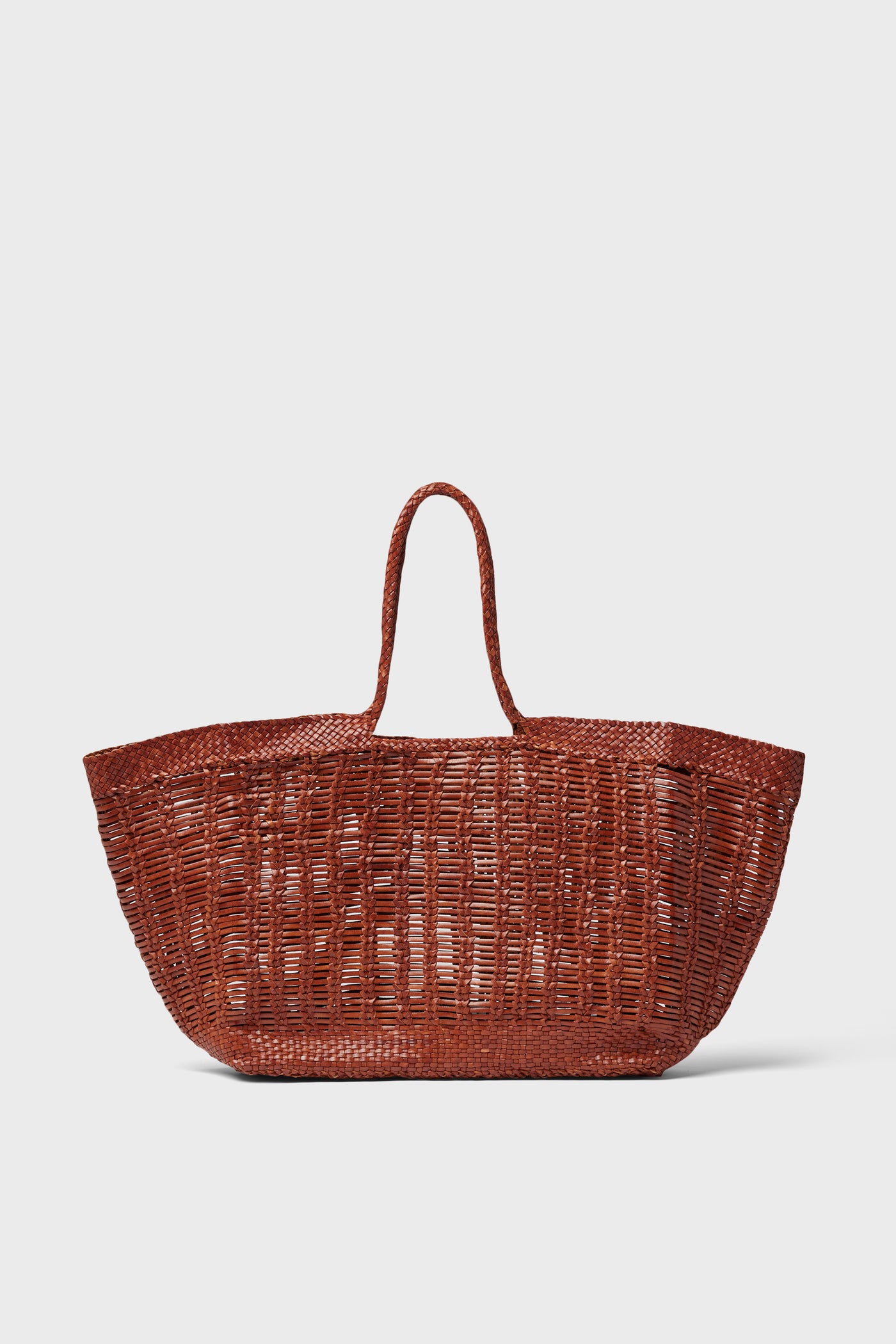 The Dragon Diffusion tote is a large, brown, handwoven bag with two handles, expertly crafted from buffalo calf leather.