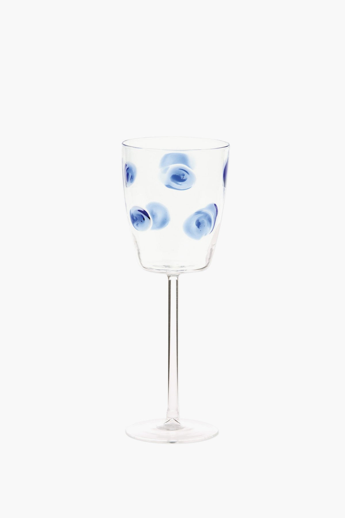 Vietri handmade wine glass featuring blue circular swirl patterns evenly distributed on the bowl, inspired by Italian barware.