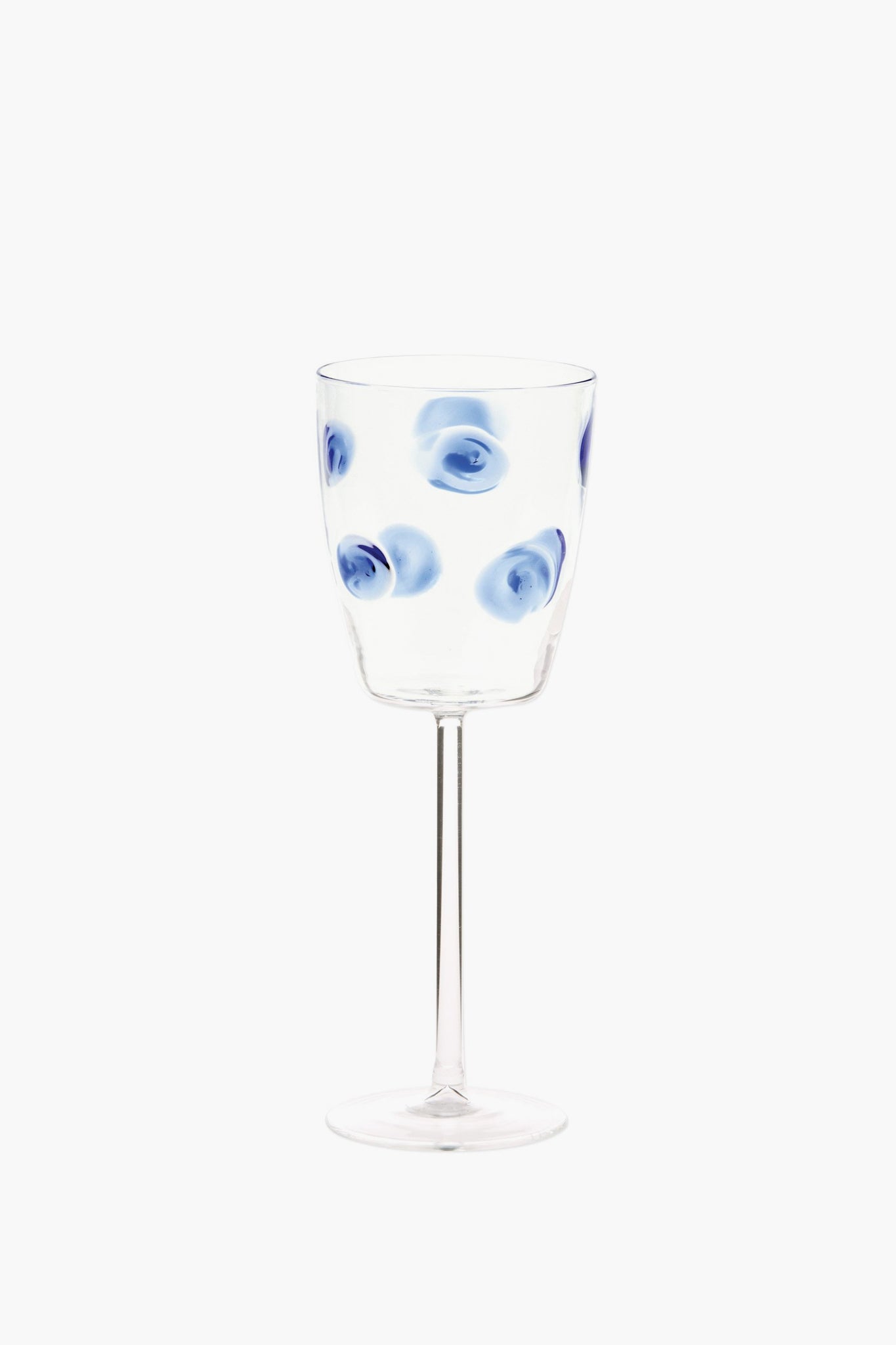 Vietri handmade wine glass featuring blue circular swirl patterns evenly distributed on the bowl, inspired by Italian barware.