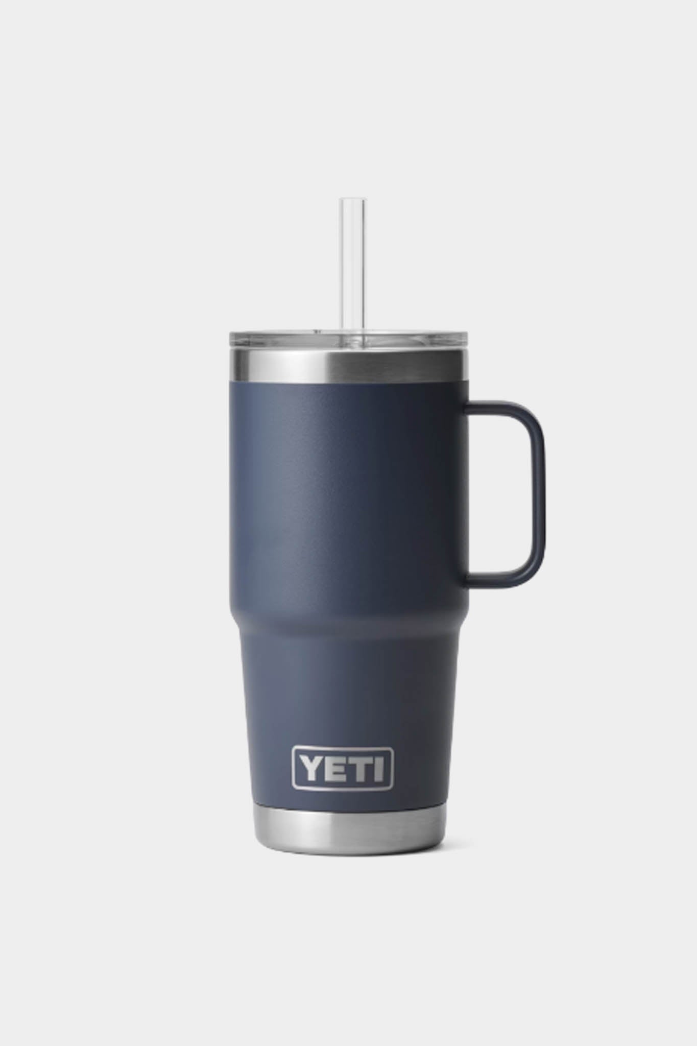 A YETI Rambler insulated straw mug in navy blue with a handle, stainless steel base, clear lid, and straight straw.