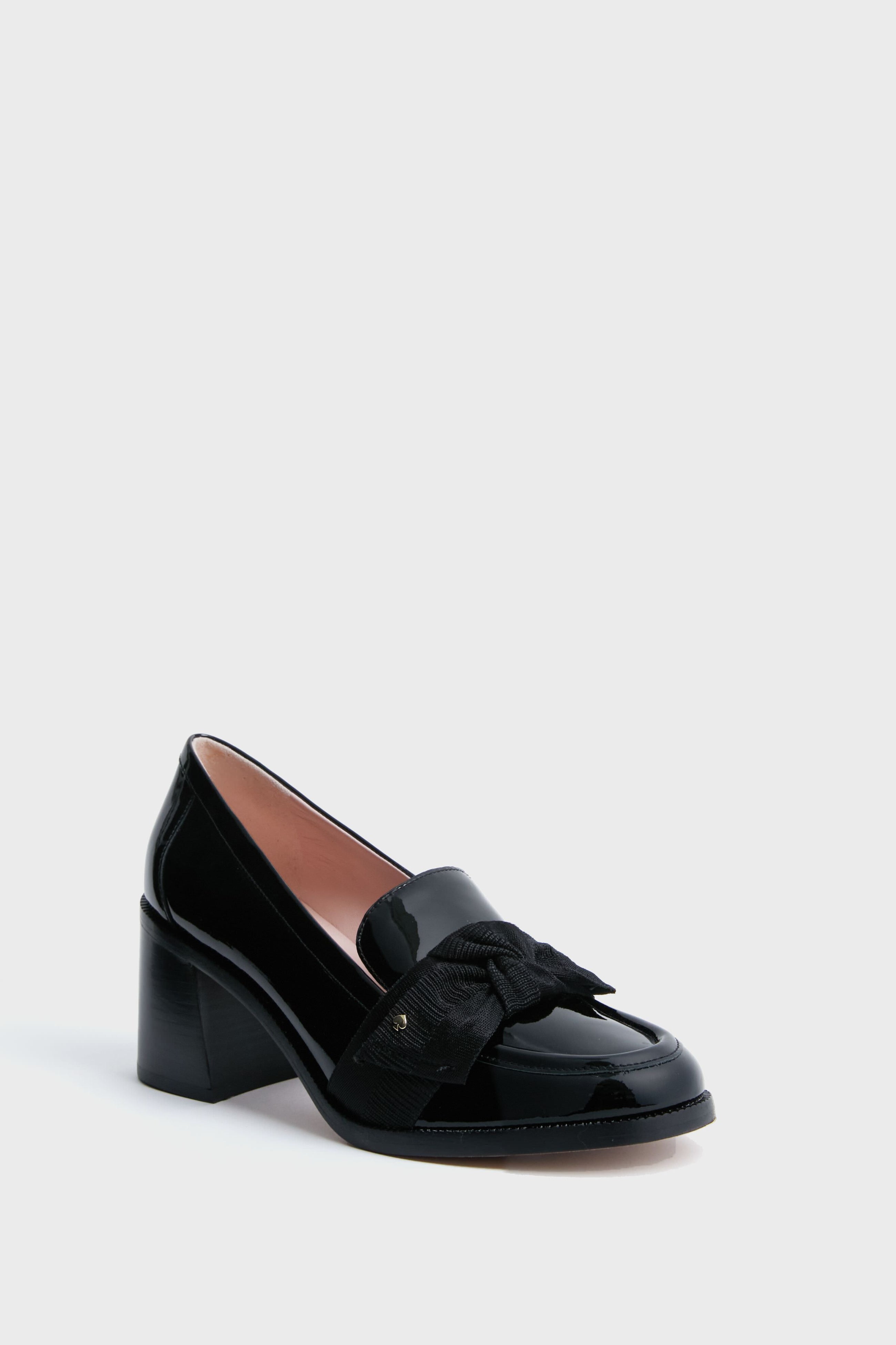 Black Leandra Heels by Kate Spade New York: a black patent leather loafer with a chunky block heel and a bold decorative bow on the front.