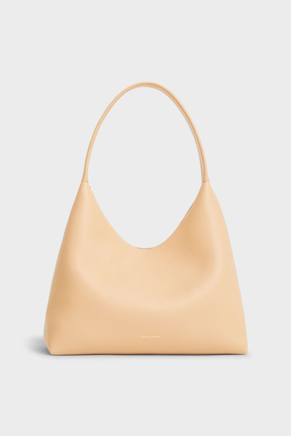 A beige Mansur Gavriel Italian leather shoulder bag with a single curved strap and minimalist design, showcasing refined style.