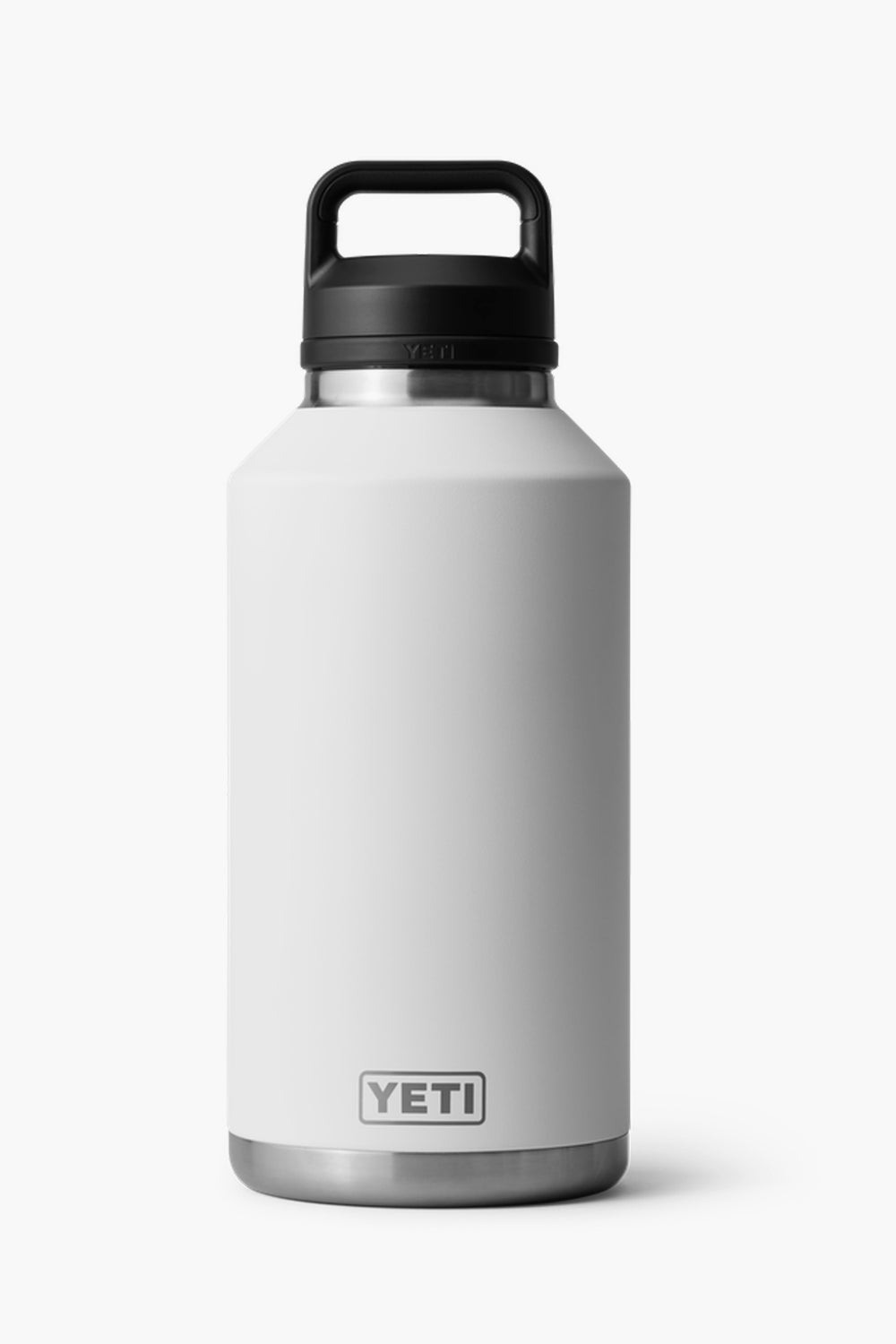 A YETI Rambler Bottle in white with a black handle lid stands upright, featuring double-wall vacuum insulation.