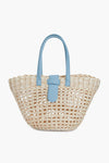 The BTB boho-chic tote bag is crafted from woven straw and features light blue leather handles with a matching blue leather strap on the front.