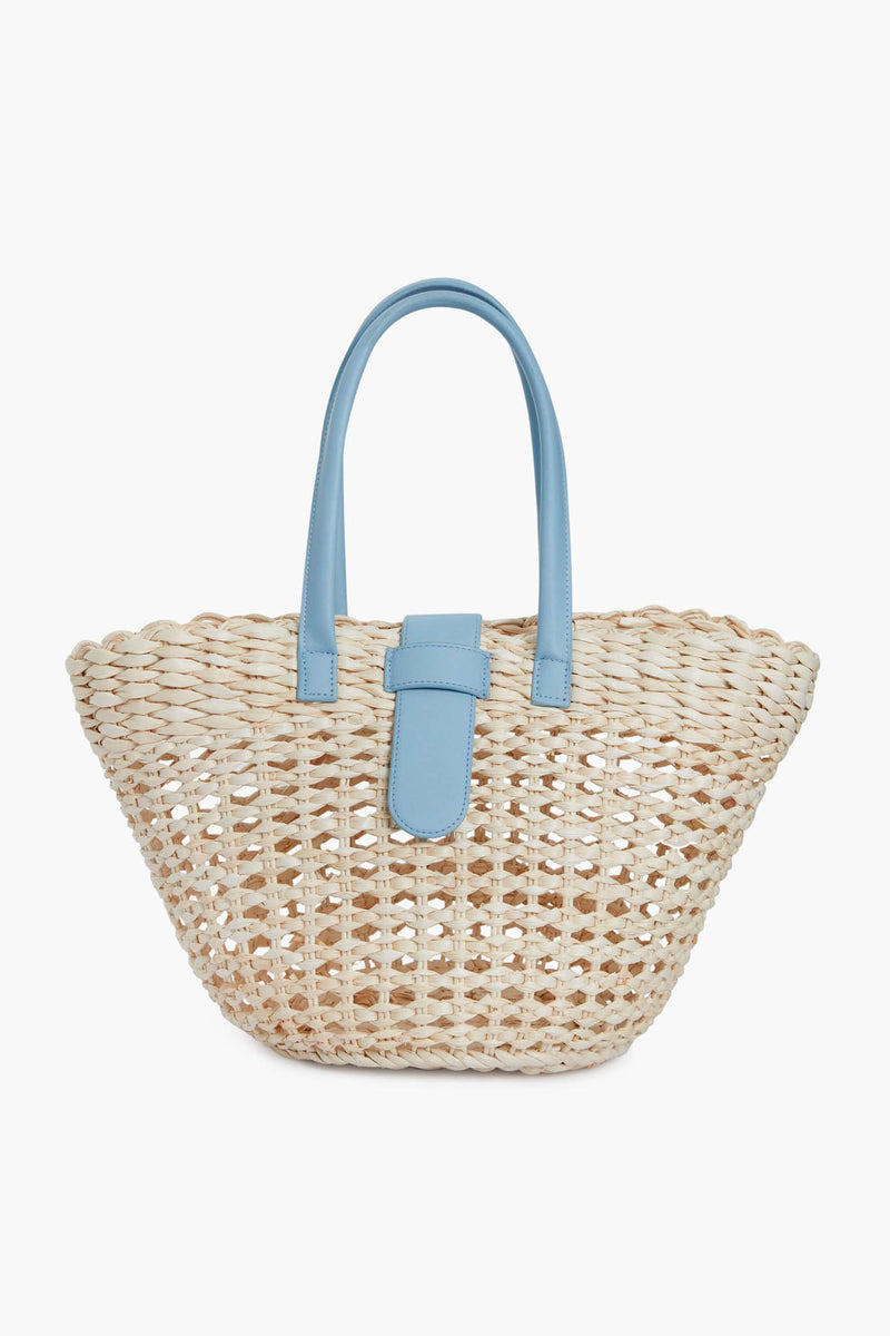 The BTB boho-chic tote bag is crafted from woven straw and features light blue leather handles with a matching blue leather strap on the front.