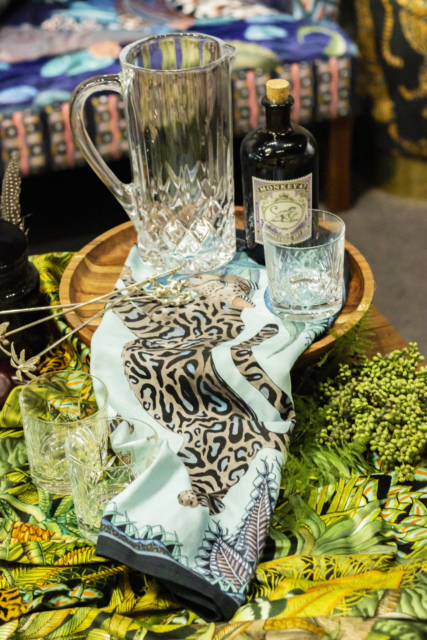 Tanzanite Cheetah Kings Tea Towel, featuring regal cheetah motifs and lush botanicals, adds classic, effortless charm to your kitchen decor with high-end, fun appeal.