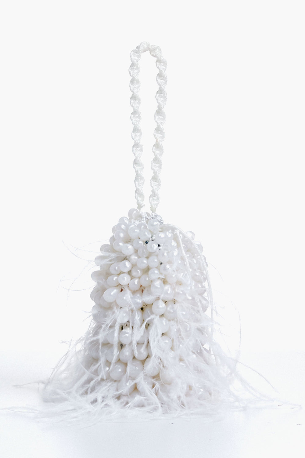 The Cult Gaia white beaded evening bag features a beaded handle and feathery white fringes at the base, making it the perfect feather wristlet for special occasions.