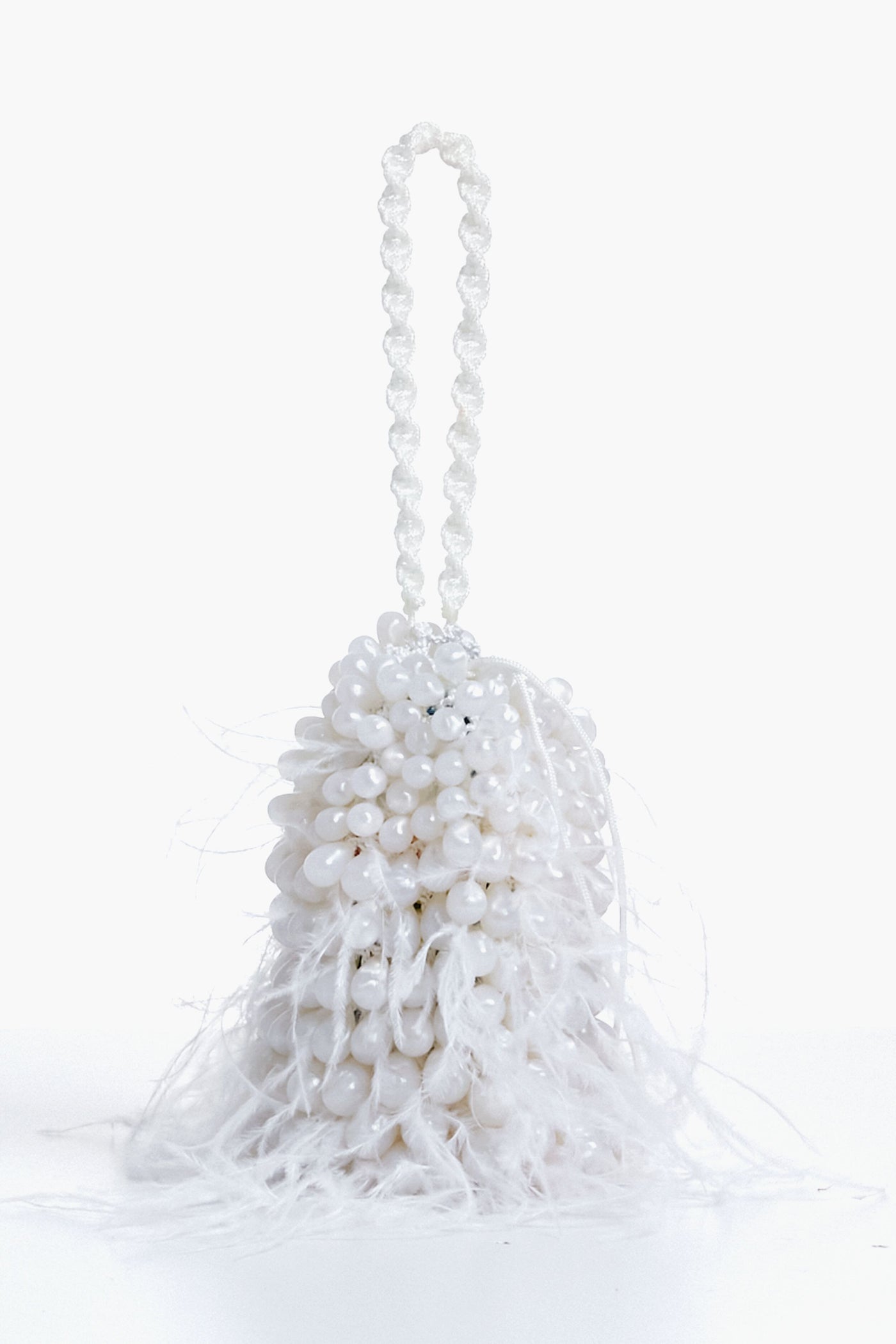 The Cult Gaia white beaded evening bag features a beaded handle and feathery white fringes at the base, making it the perfect feather wristlet for special occasions.