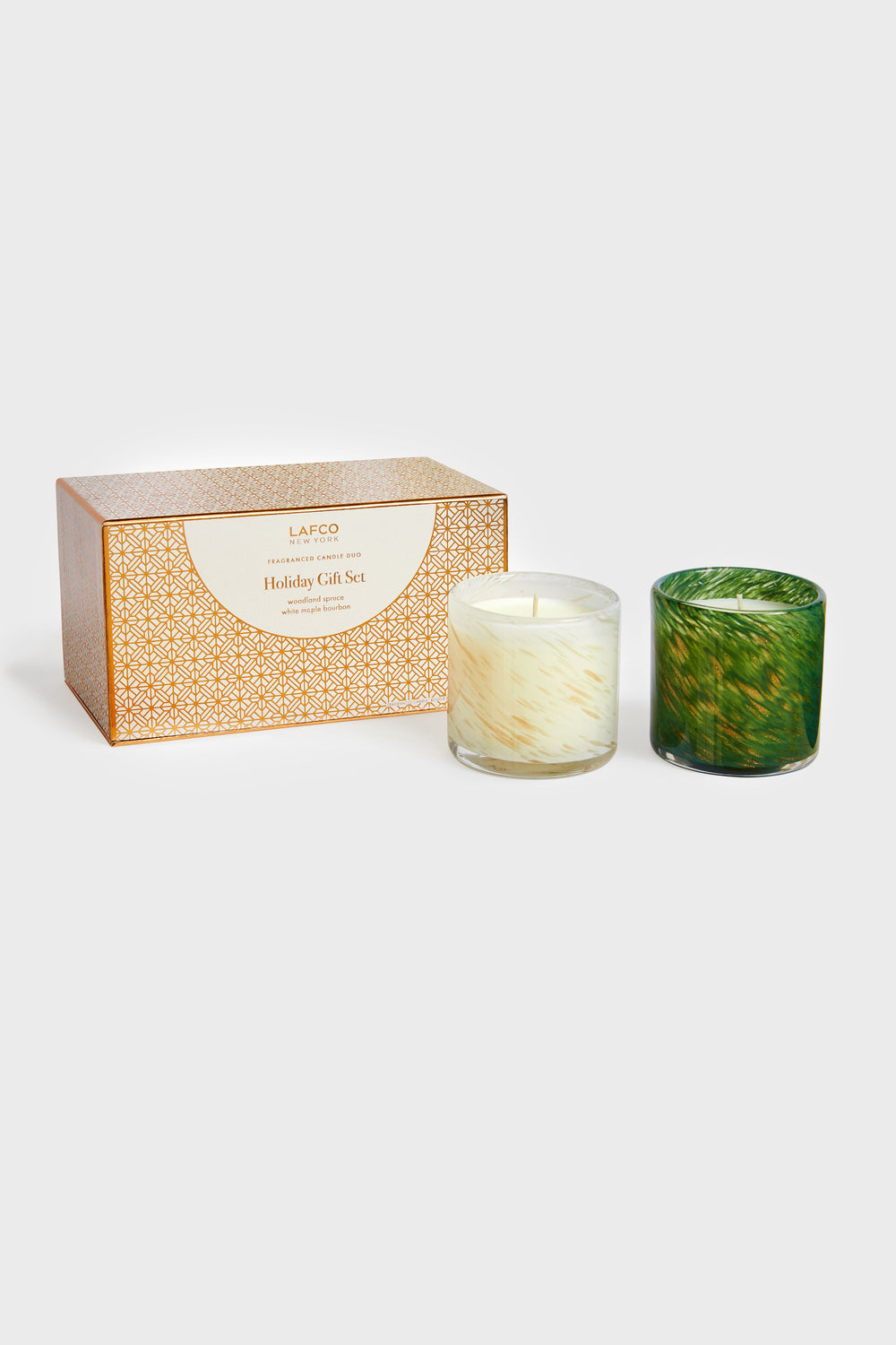 A boxed LAFCO New York Holiday Gift Set with two seasonal candles in white and green glass holders—an elegant home fragrance option and a perfect housewarming gift.