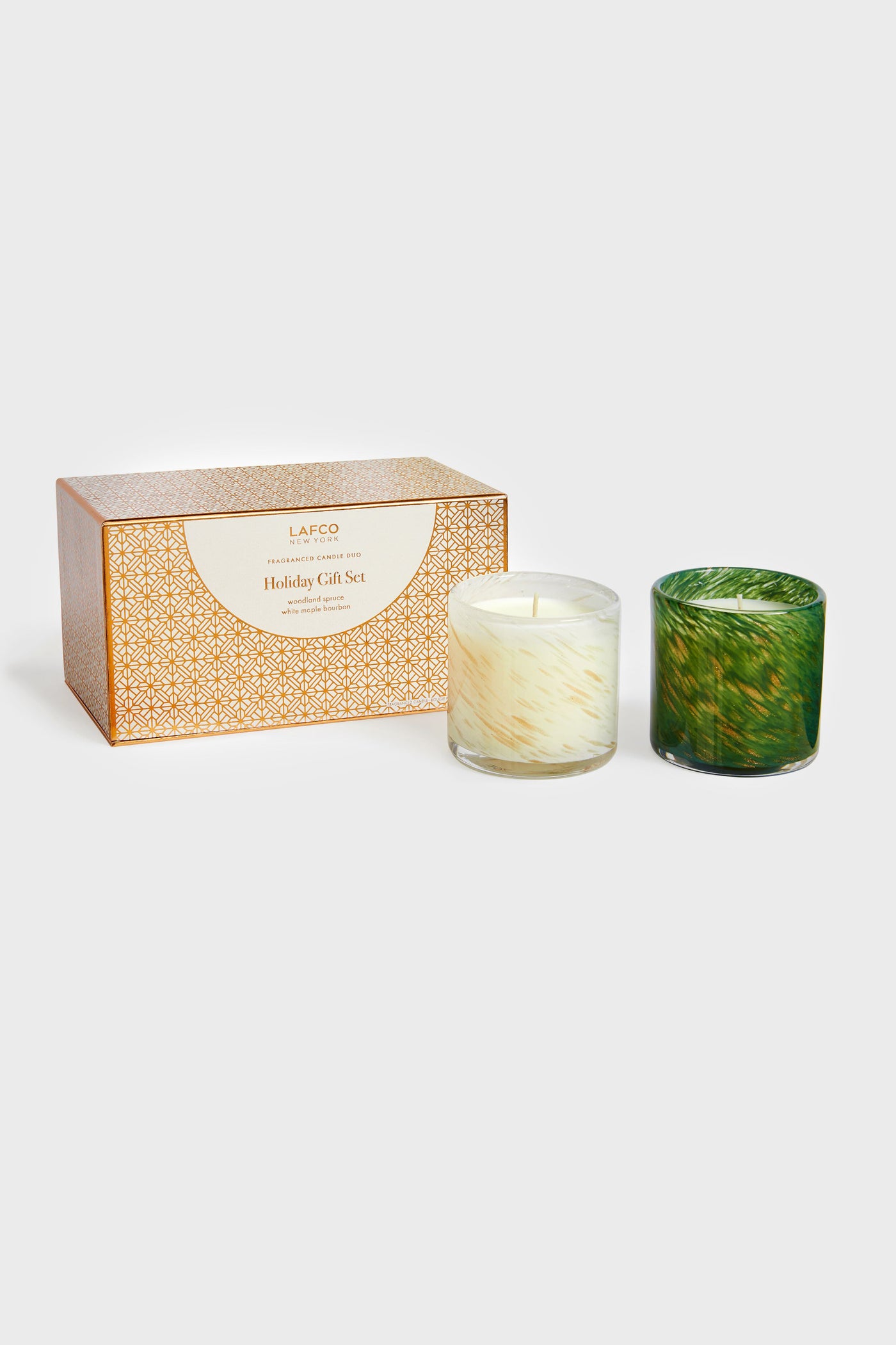A boxed LAFCO New York Holiday Gift Set with two seasonal candles in white and green glass holders—an elegant home fragrance option and a perfect housewarming gift.