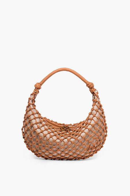 A small STAUD shoulder bag in beige, featuring a rounded shape with a brown woven net overlay and a matching brown handle.