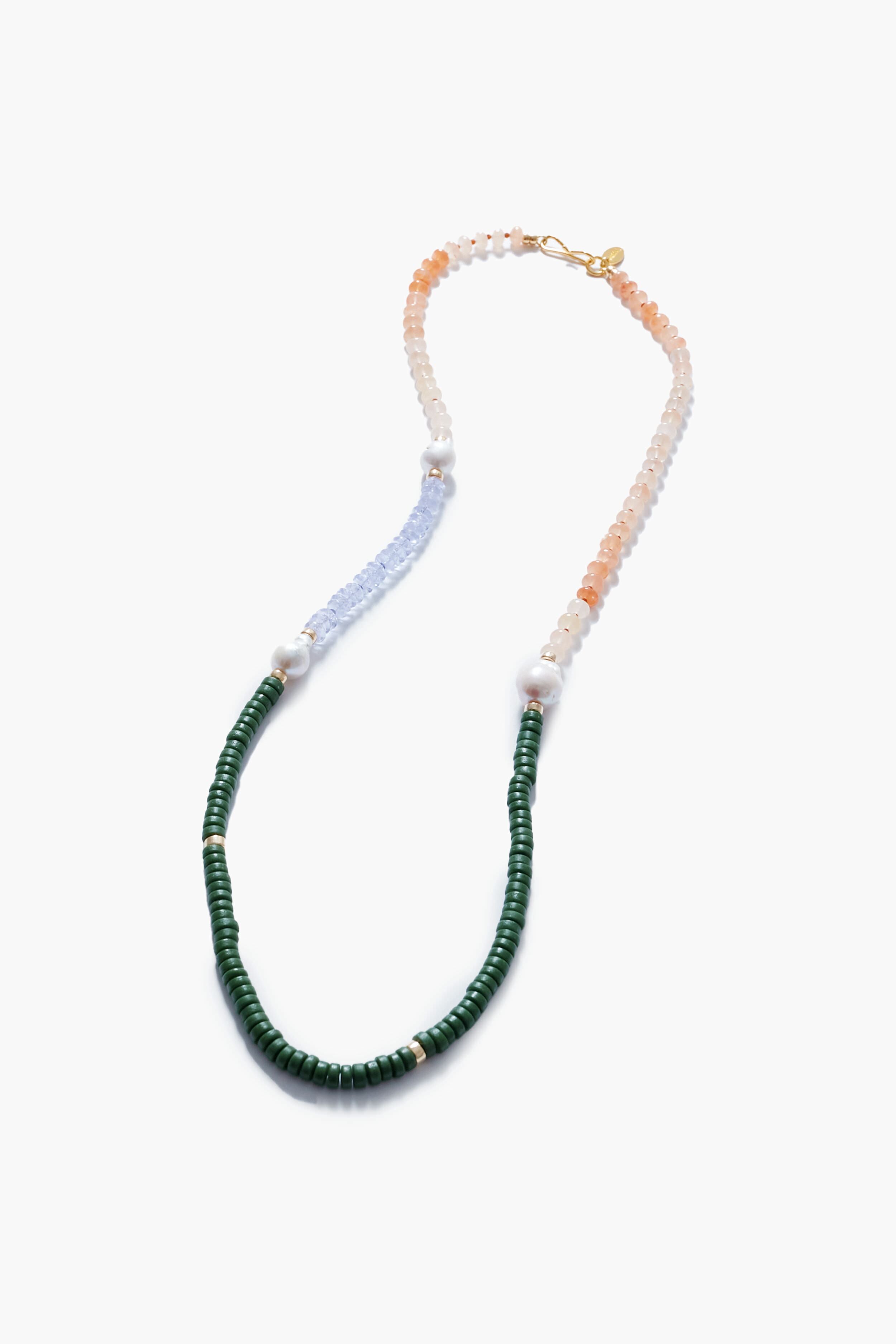 Lizzie Fortunato’s handcrafted multi-beaded necklace features green, peach, and light blue beads, accented with white pearls and a gold clasp—a fresh take on the classic freshwater pearl necklace.