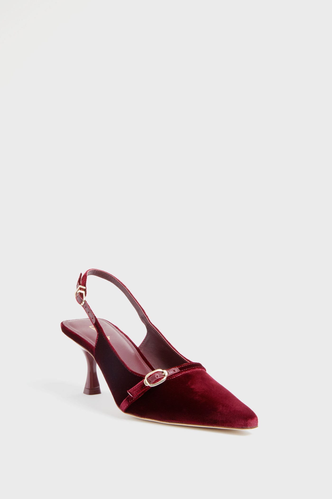 The Larroude wine velvet slingback heel features a pointed toe, stiletto heel, and a thin strap with a small buckle detail.