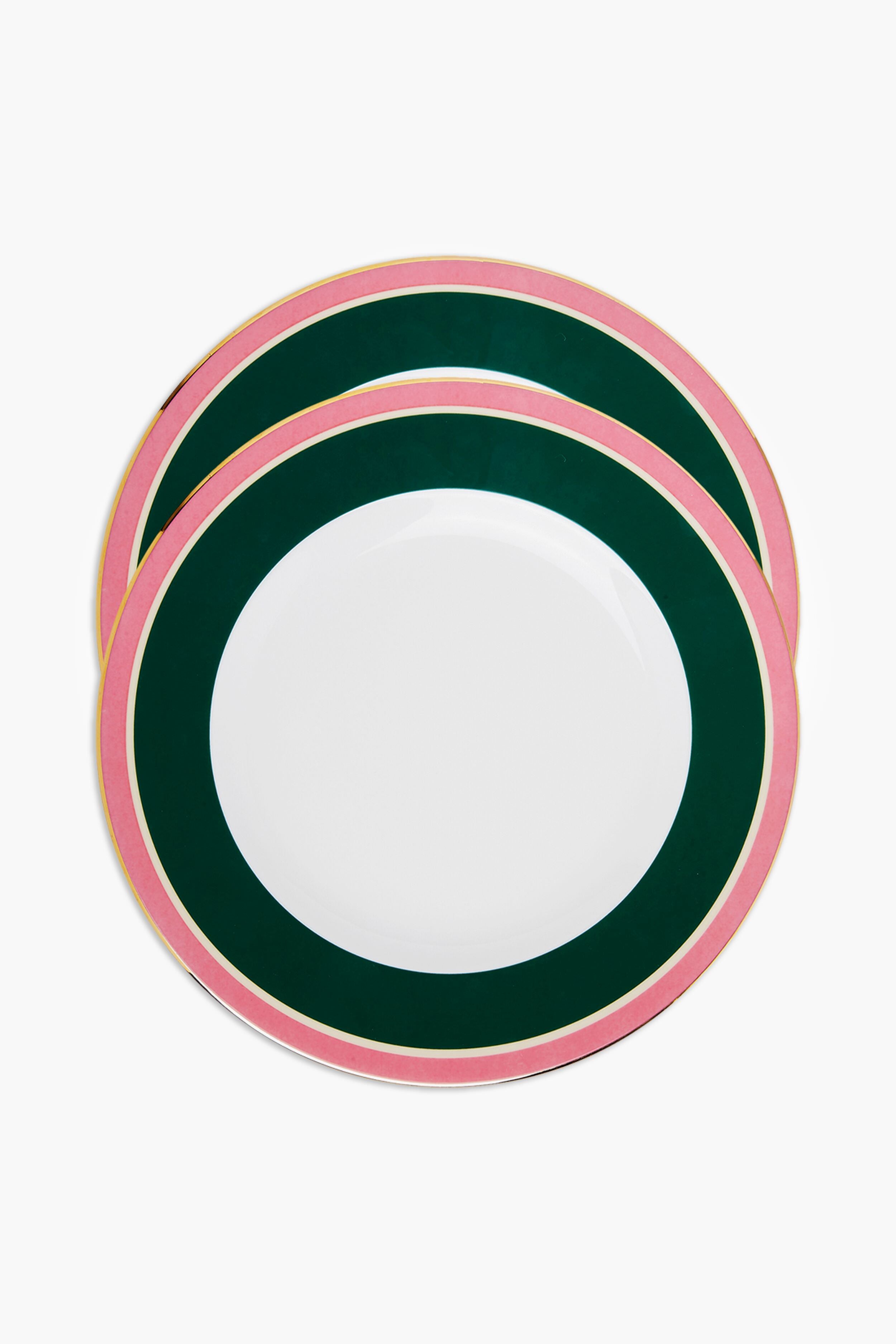 Two round La DoubleJ Italian porcelain dinner plates with a white center, dark green inner rim, and pink outer rim are stacked slightly offset. Elegant hand-painted 18k gold trim adds luxury to this colorful tableware.