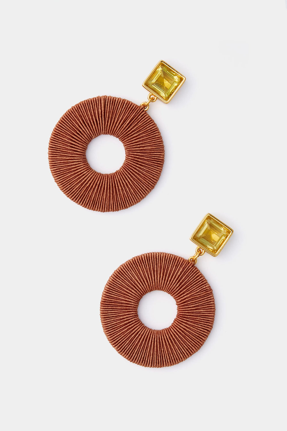 Lizzie Fortunato’s Brown Palmier Earrings feature round, textured brown hoops paired with square, yellow gemstone studs.