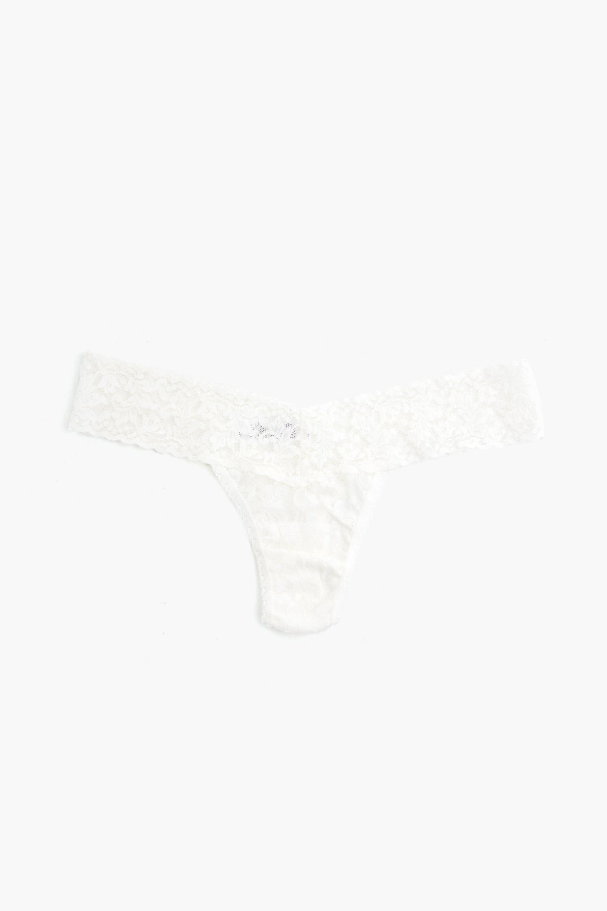 A white Hanky Panky low-rise thong crafted from stretch lace is shown laid flat.