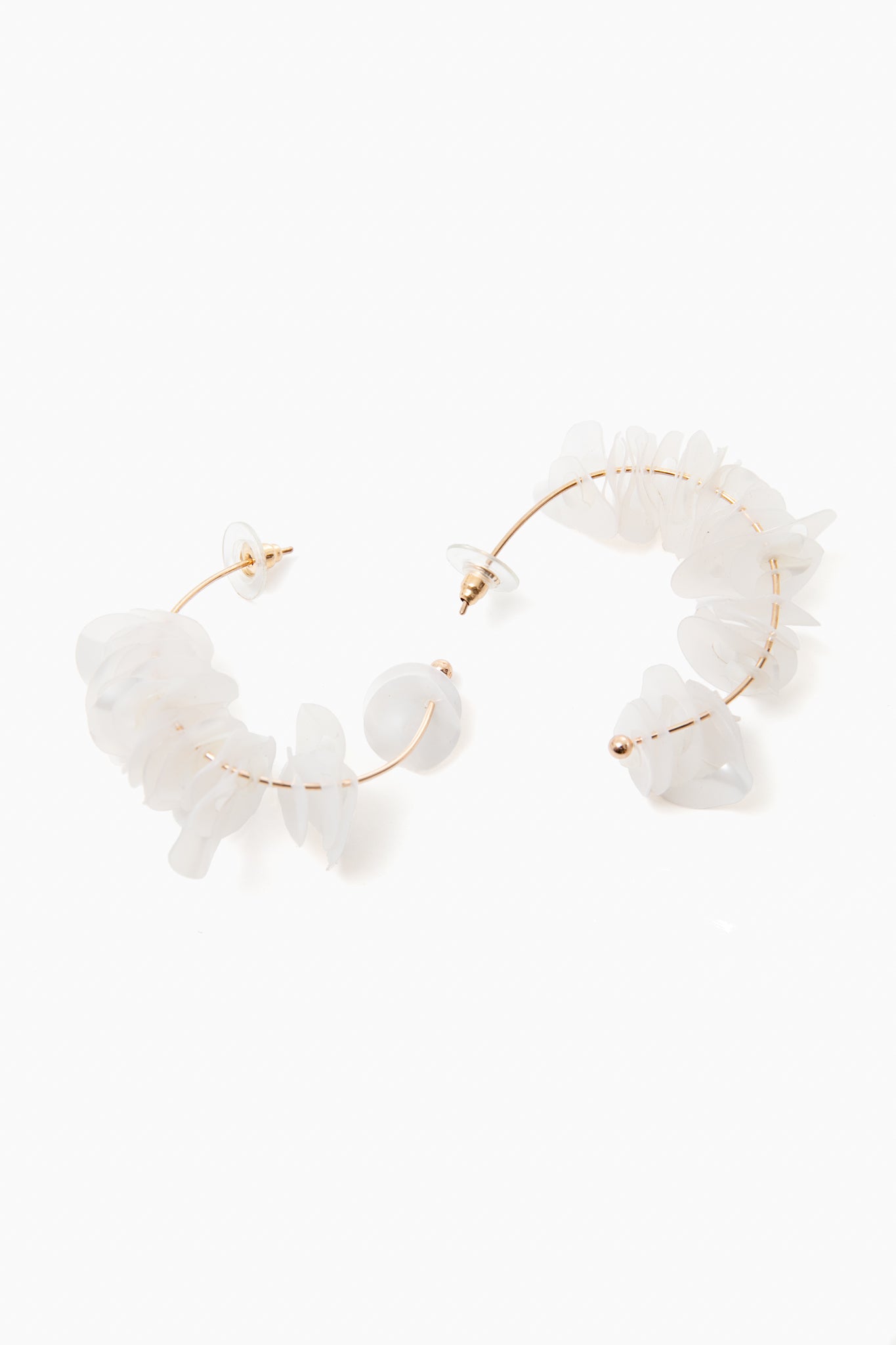 Mignonne Gavigan 18K gold-plated hoops featuring irregular translucent white stones and mother of pearl accents.