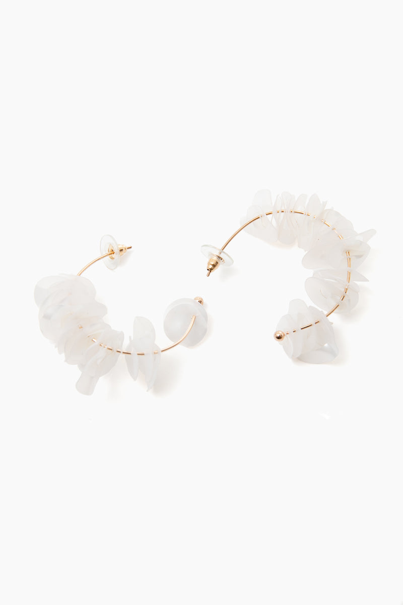 Mignonne Gavigan 18K gold-plated hoops featuring irregular translucent white stones and mother of pearl accents.