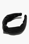 Lele Sadoughi black velvet padded headband with a twist knot detail.