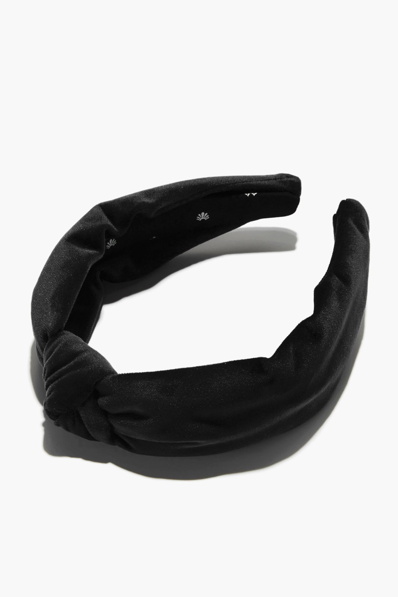 Lele Sadoughi black velvet padded headband with a twist knot detail.