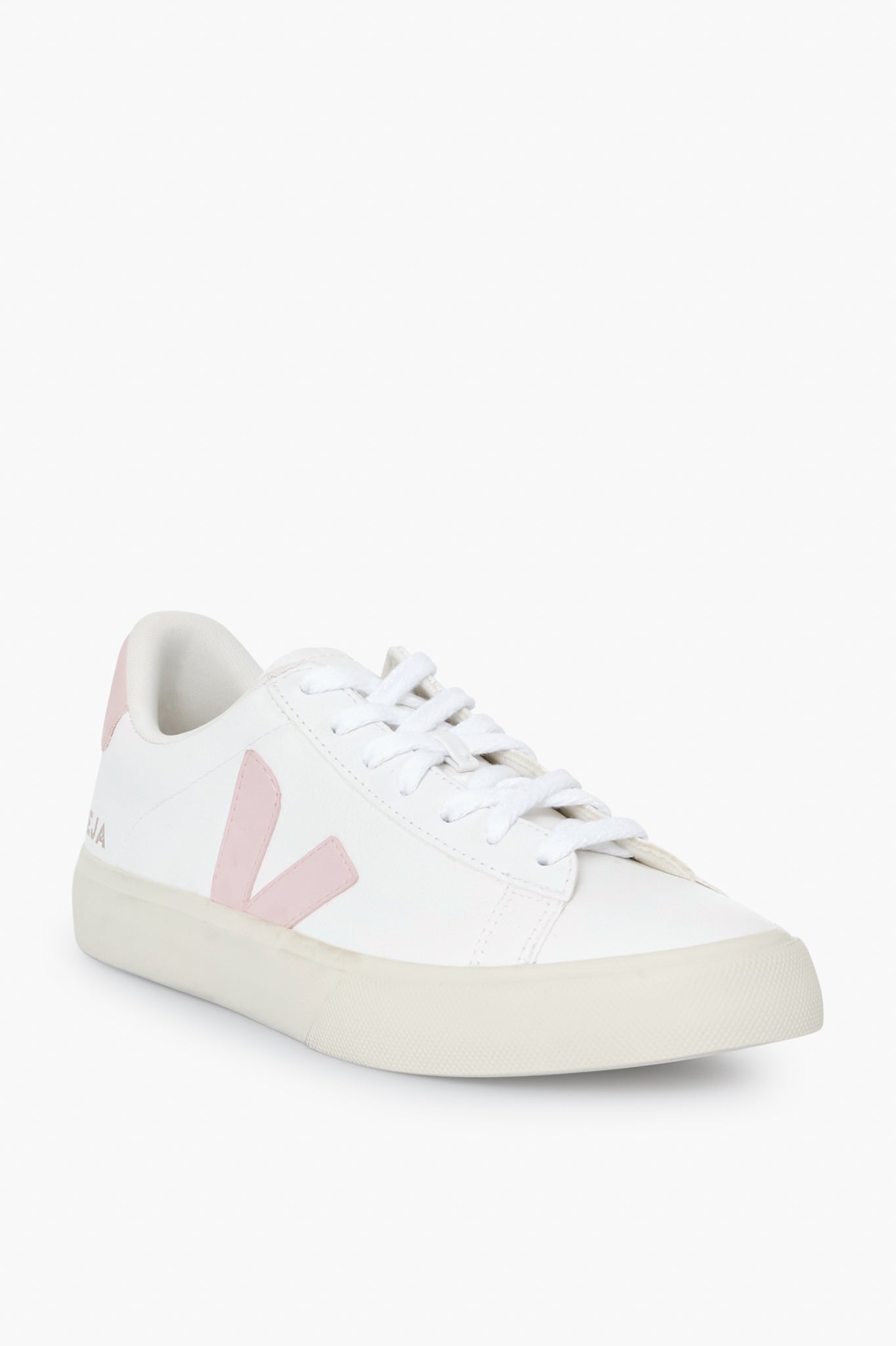 The VEJA low-top sneaker features a white upper, light pink detailing, white laces, and a beige rubber sole, showcasing the brand's stylish and sustainable design.