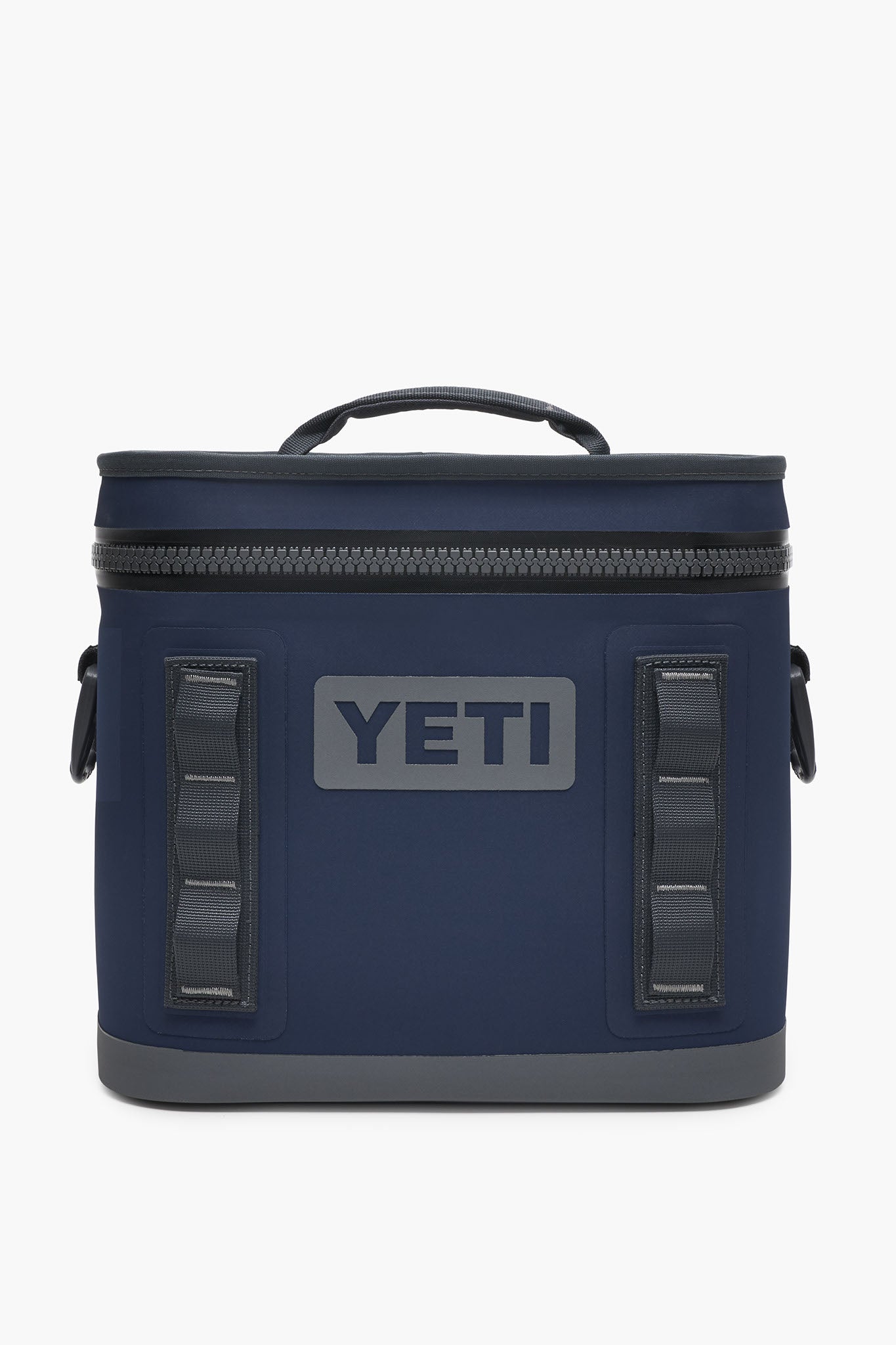 A navy blue YETI Hopper Flip cooler featuring a waterproof zipper top, side handles, and the YETI logo on the front.