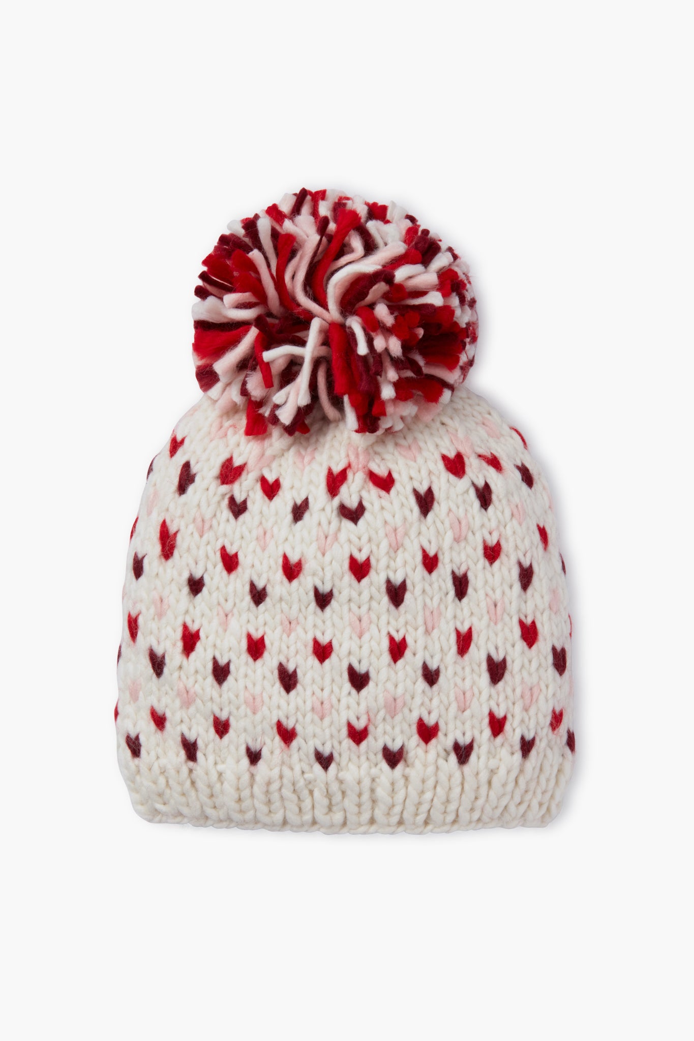 The Look by M white knit hat features red and pink heart patterns and a large red-and-white pompom, making this handmade beanie perfect for cozy style.