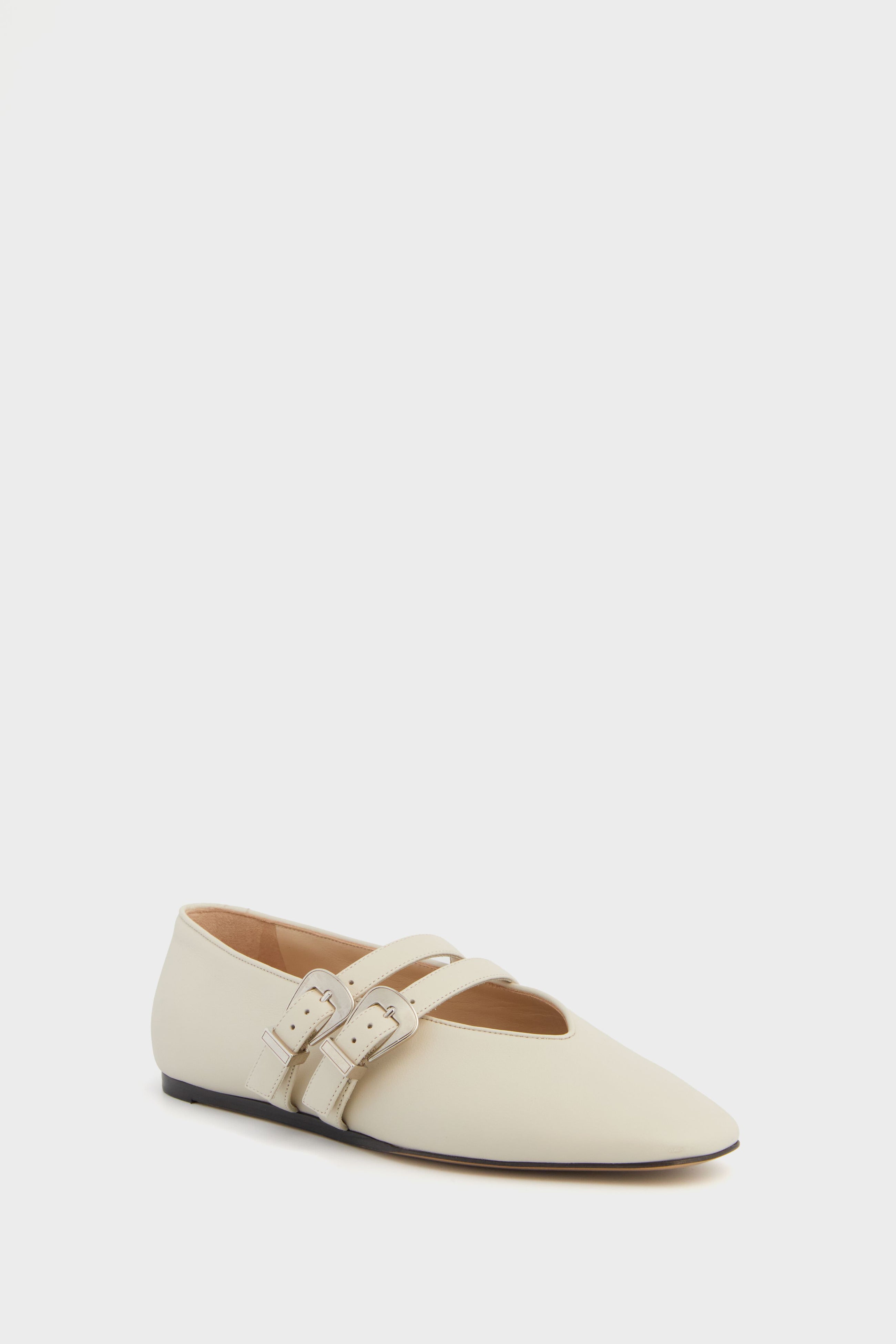 A cream-colored leather Mary Jane shoe by Le Monde Beryl, made in Italy, featuring two tan buckle straps across the top.