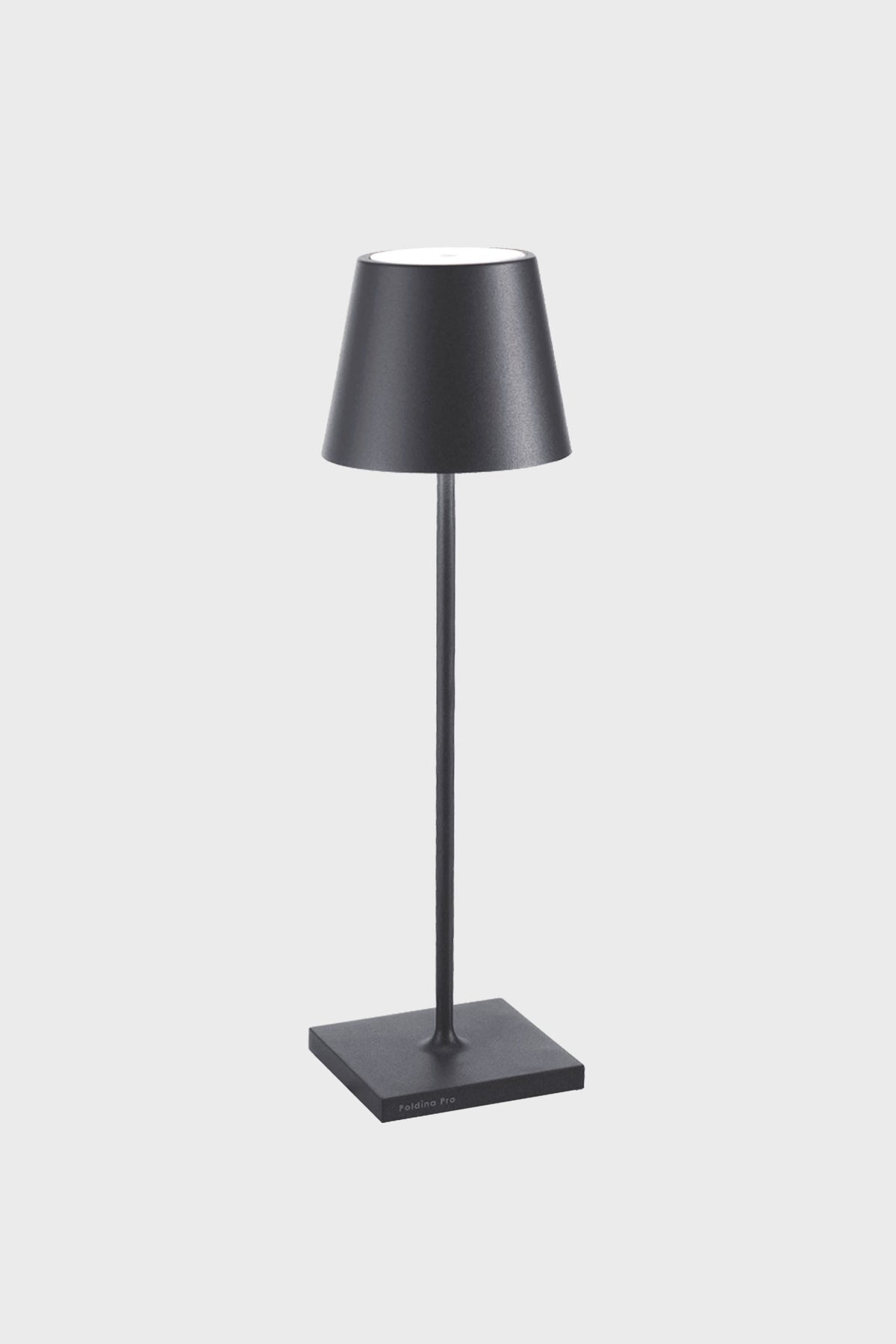 A black Zafferano Poldina Pro Table Lamp on a stand, featuring a rechargeable battery for cordless LED lighting convenience.