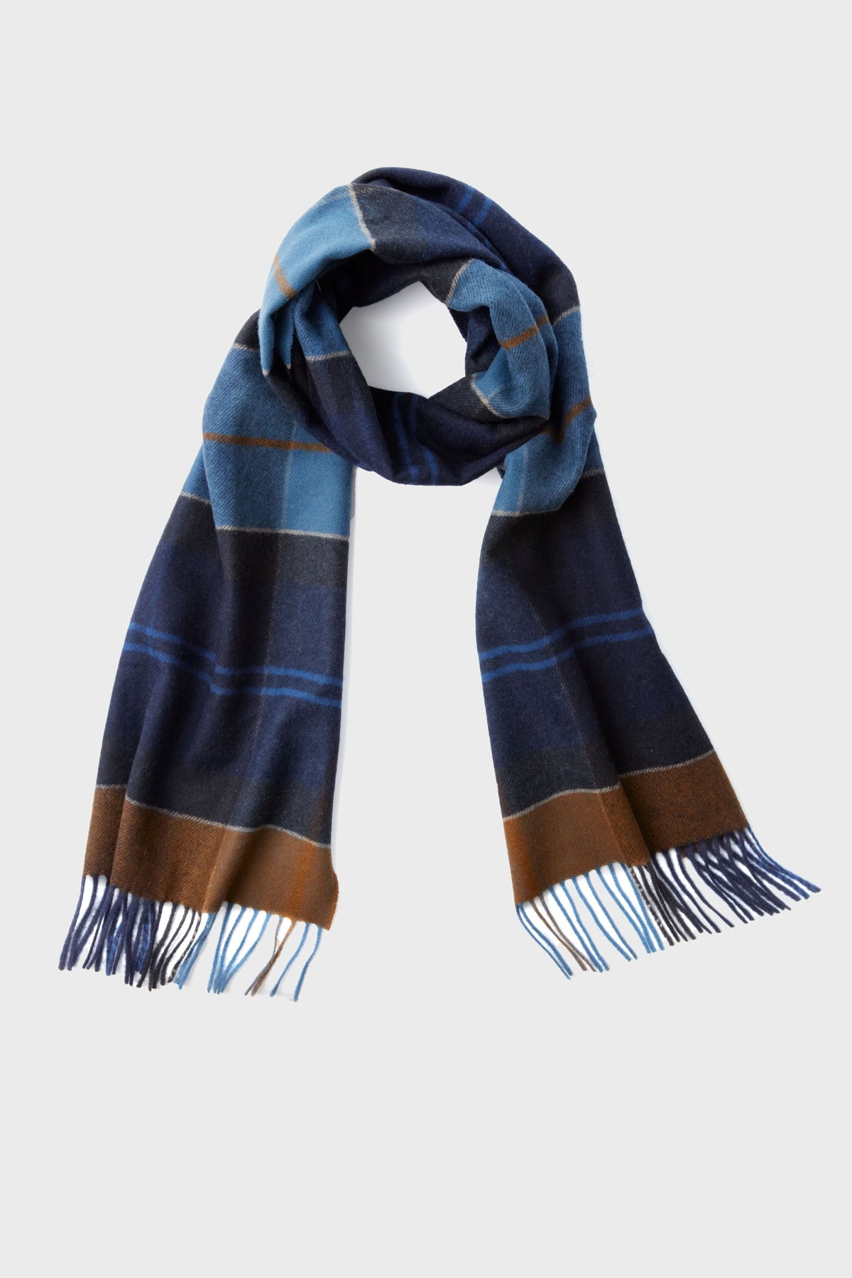 The Barbour heritage wool scarf features a blue, brown, and black plaid pattern with fringe at both ends, blending classic style and luxurious warmth.
